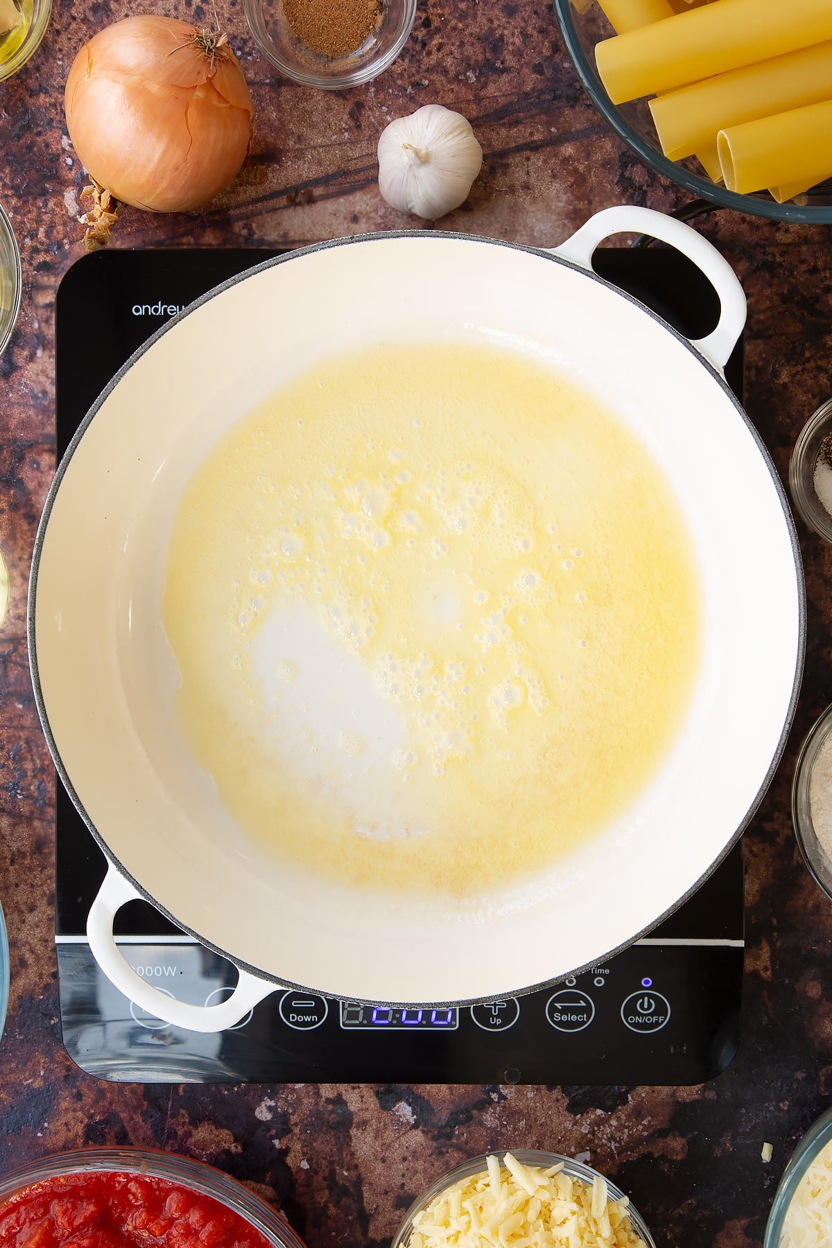 Overhead shot of butter and oil being melted in a pan.