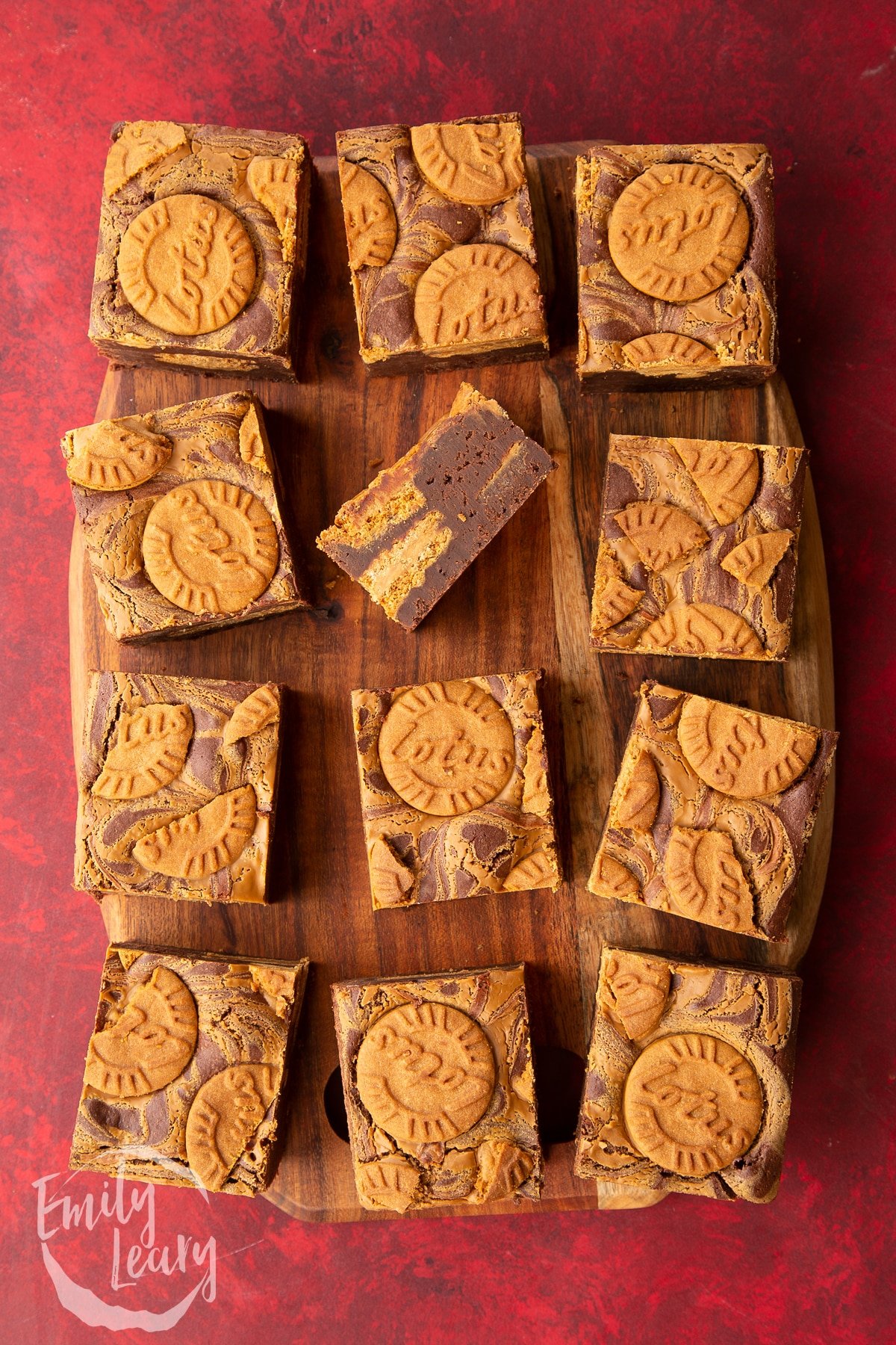 square biscoff brownies on a wooden chopping board.