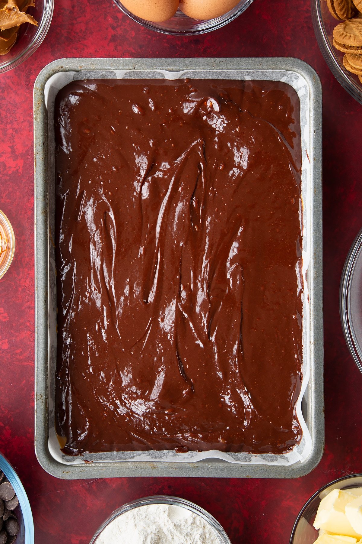 brownie batter in a large lined baking tin.