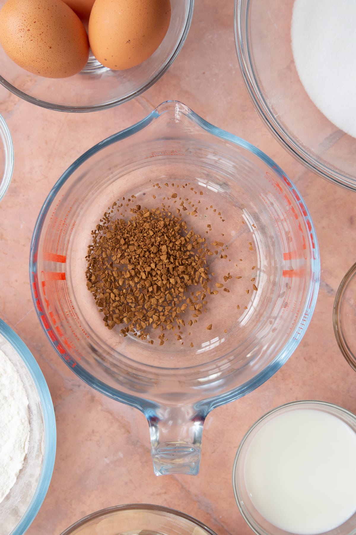 coffee grounds in a glass measuring jug.