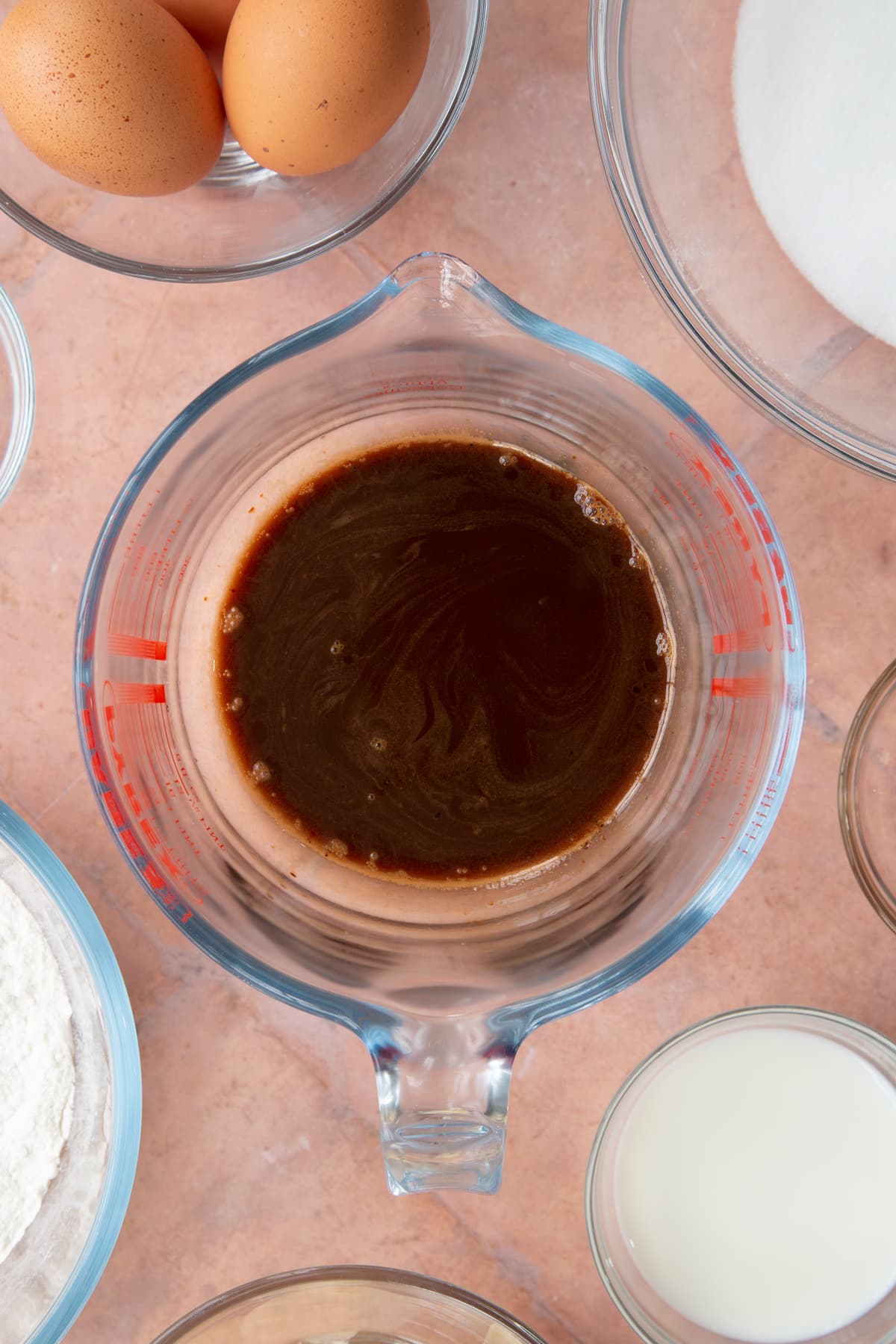 dissolved coffee grounds in a glass measuring jug.