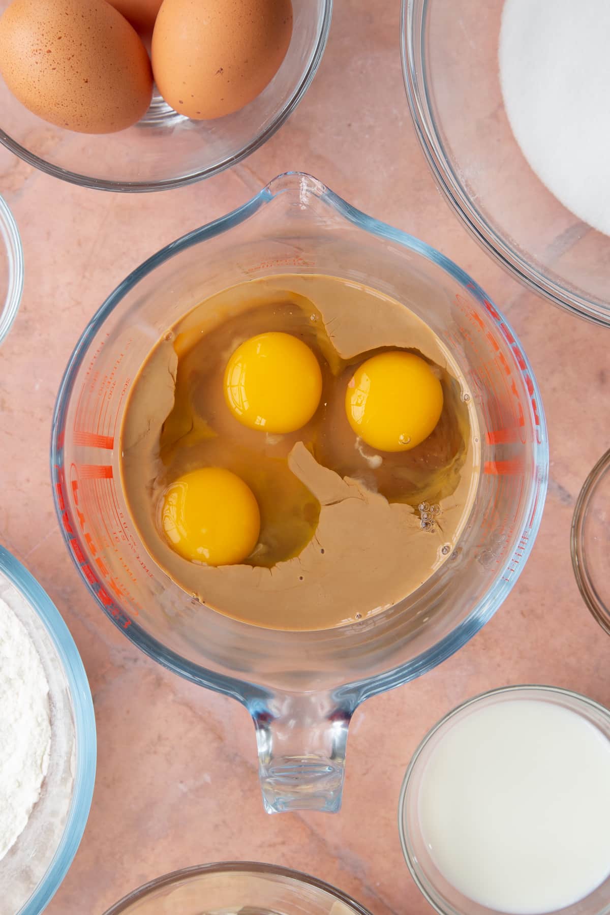 dissolved coffee grounds in a glass measuring jug with 3 eggs.
