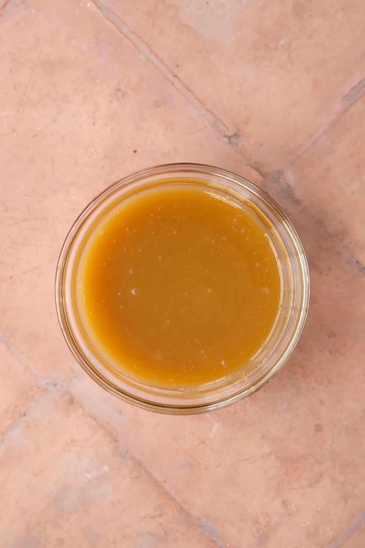 caramel sauce in a small clear bowl.