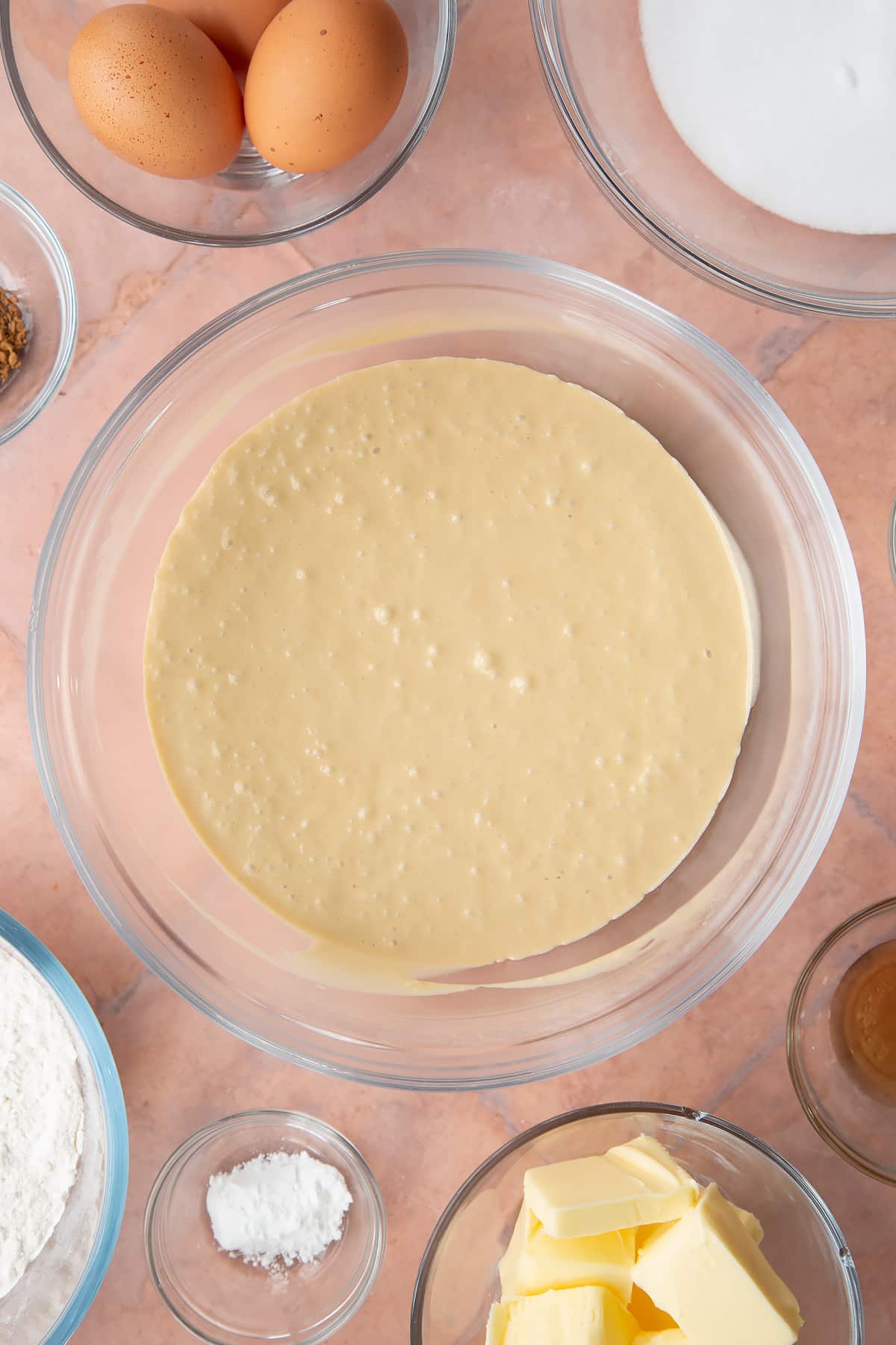 mixed butter and sugar mix with coffee in a large clear bowl.