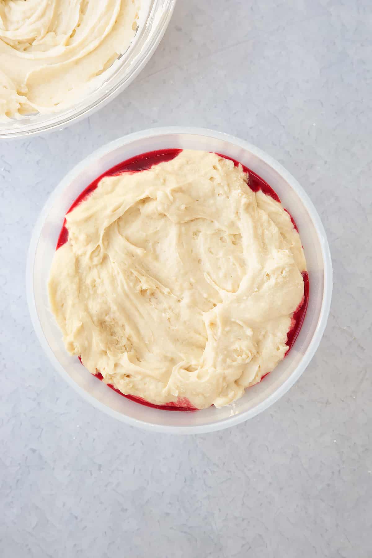 fruit mix in the bottom of a pudding basin topped with vanilla cake batter.