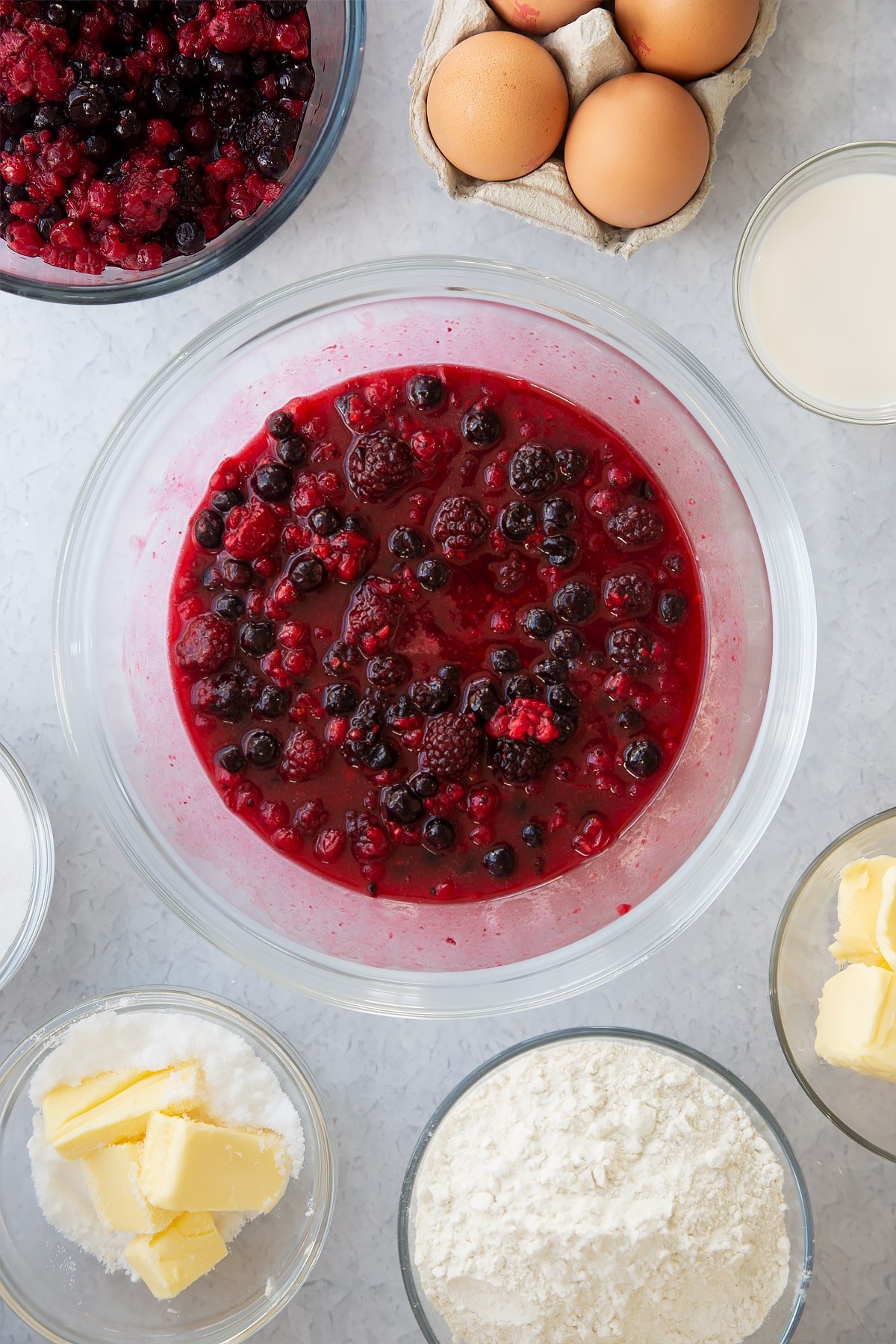 microwaved fruit, butter and sugar mixture in a large clear bowl.