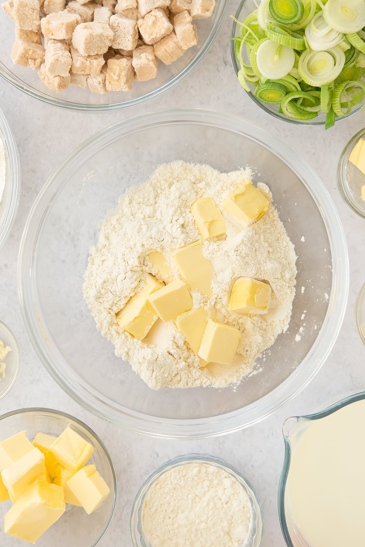 flour and chunks of butter in a large clear bowl.