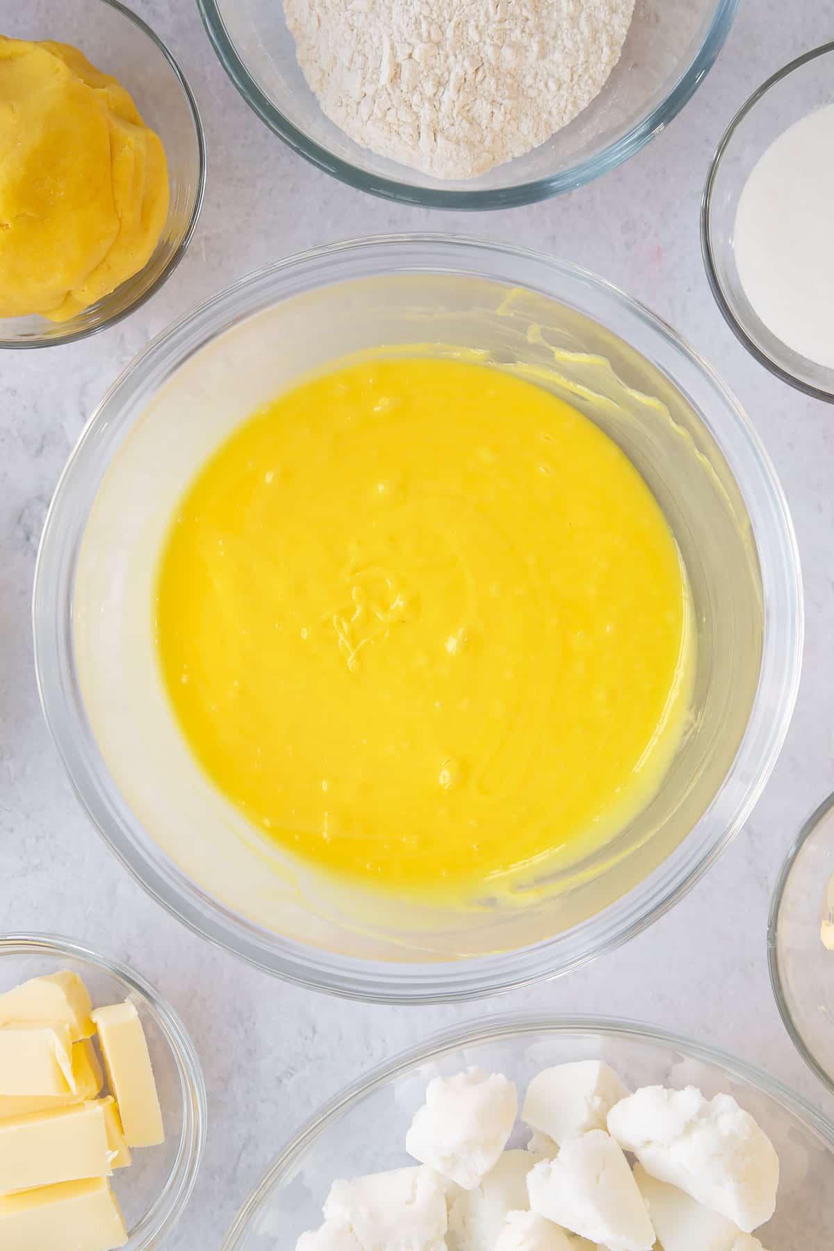 Whisking the lemon food colouring into the icing. 