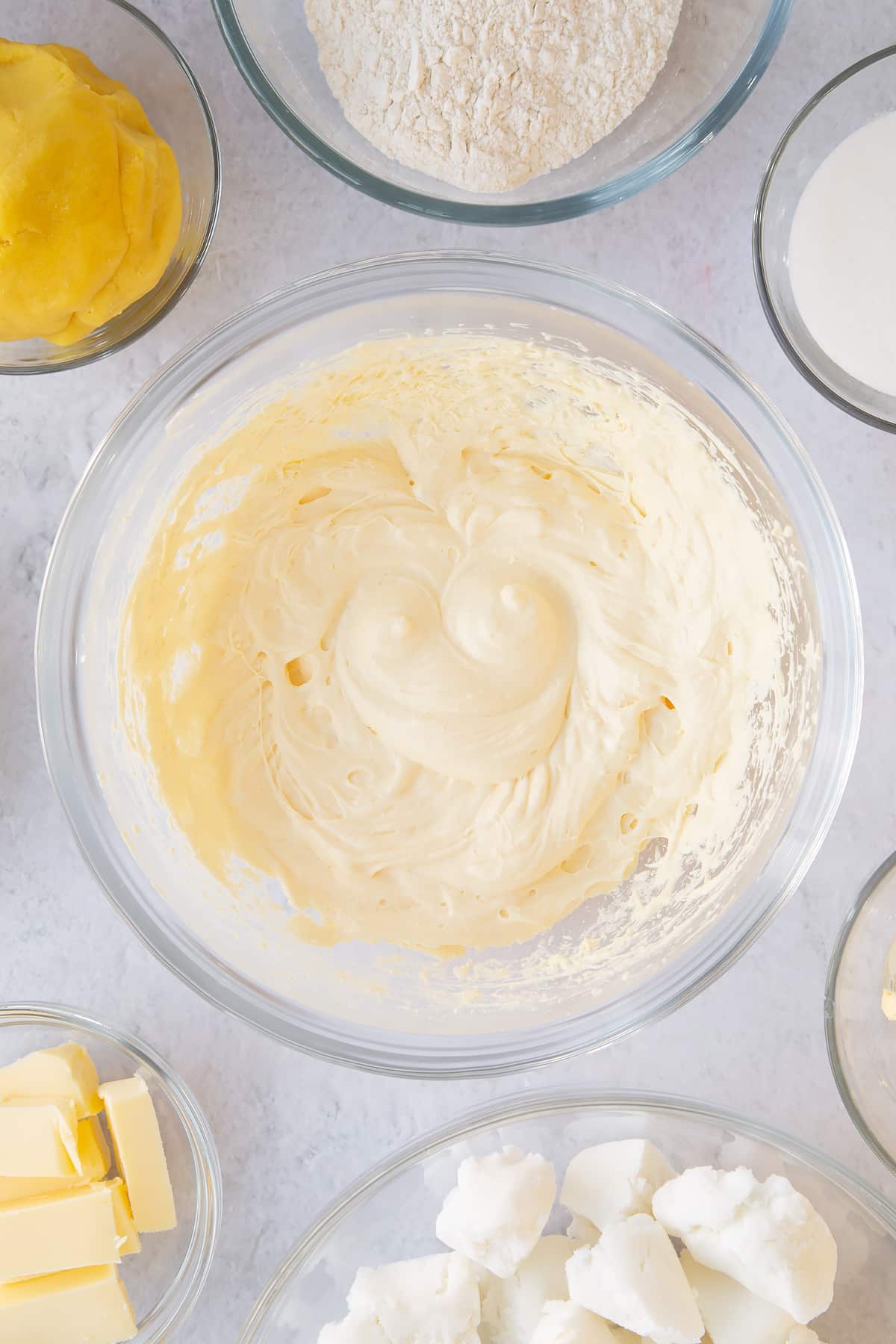 Sugar, butter and eggs having been whisked in a mixing bowl.