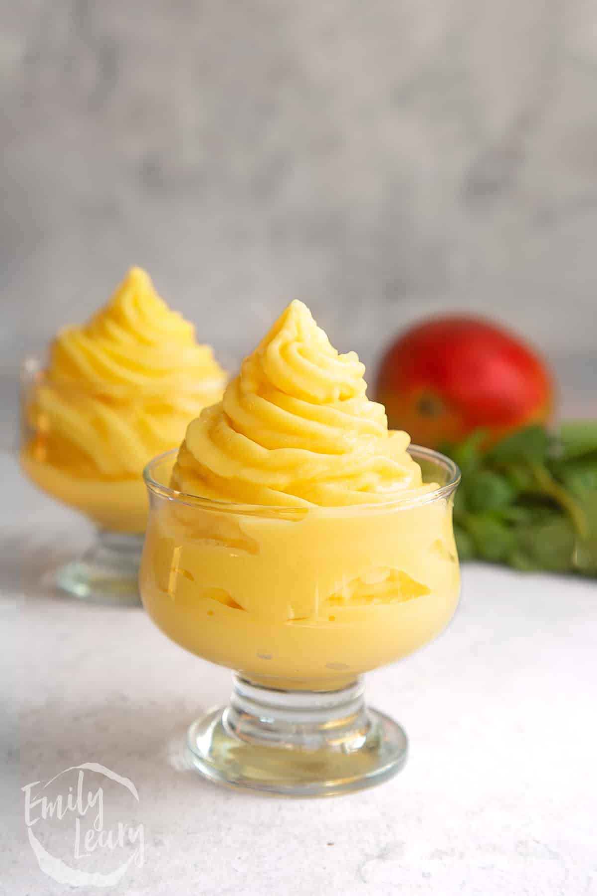 a decadent glass filled with mango ice cream.