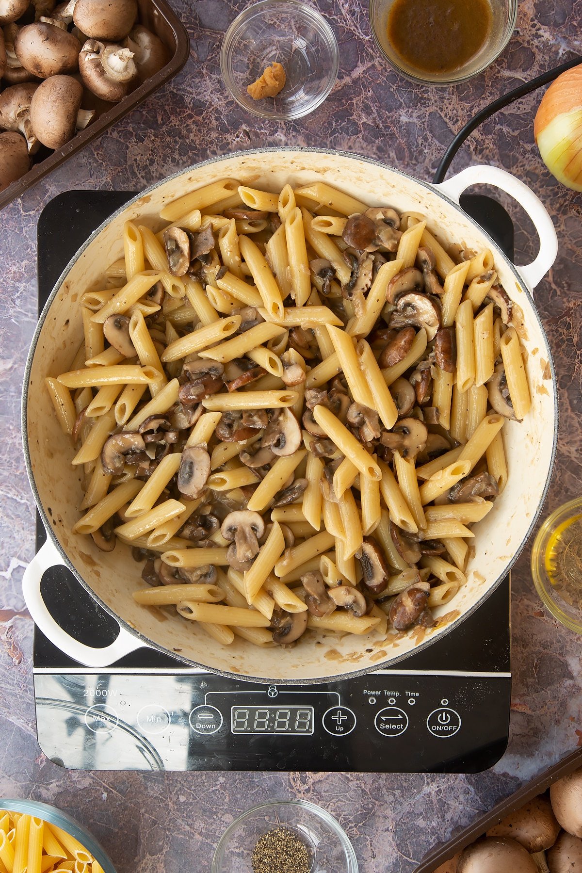 miso mushroom pasta cooked and mixed together in a large frying pan.