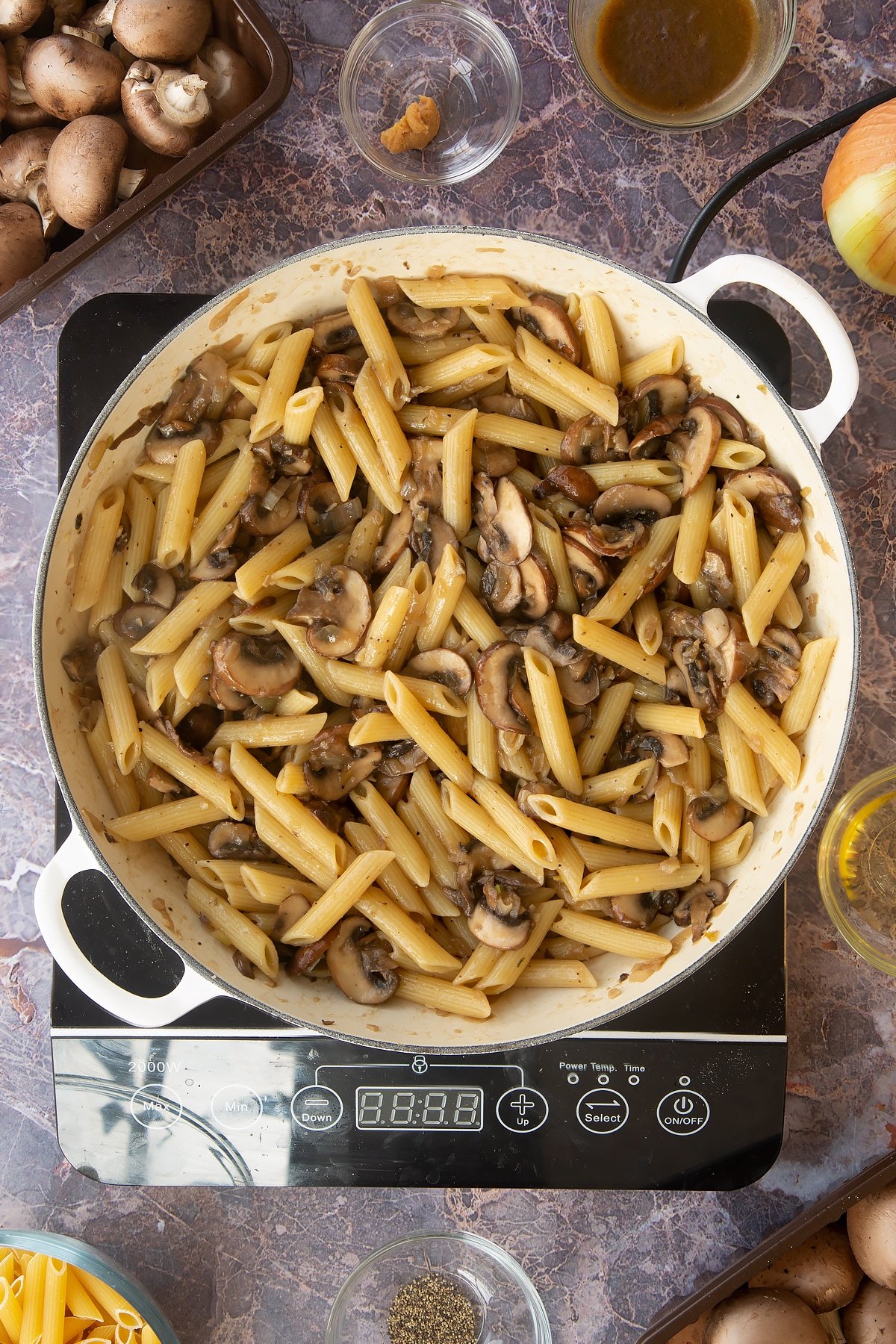 miso mushroom pasta cooked and mixed together in a large frying pan.