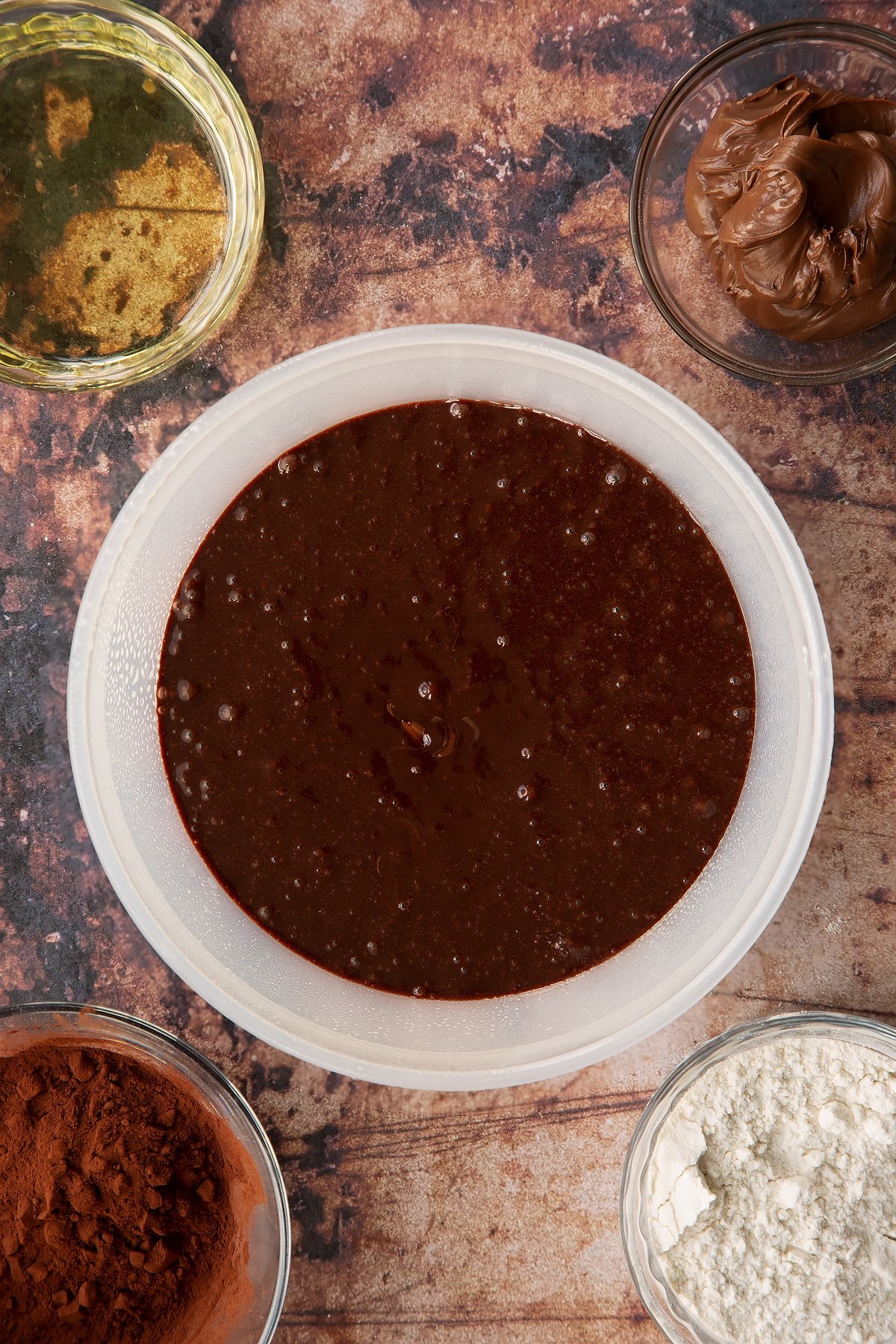 Nutella pudding cake batter in a greased cake dish.