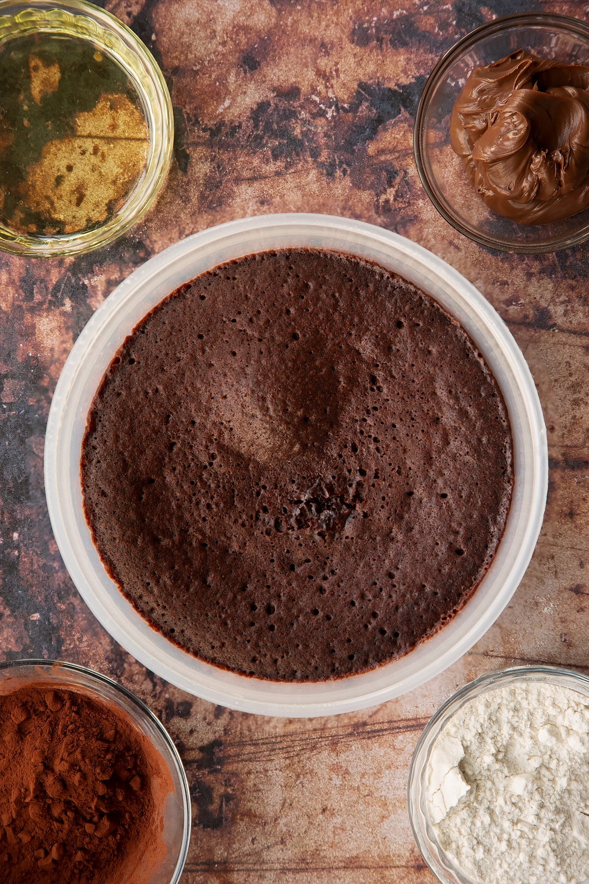 baked Nutella pudding cake batter in a pudding dish.