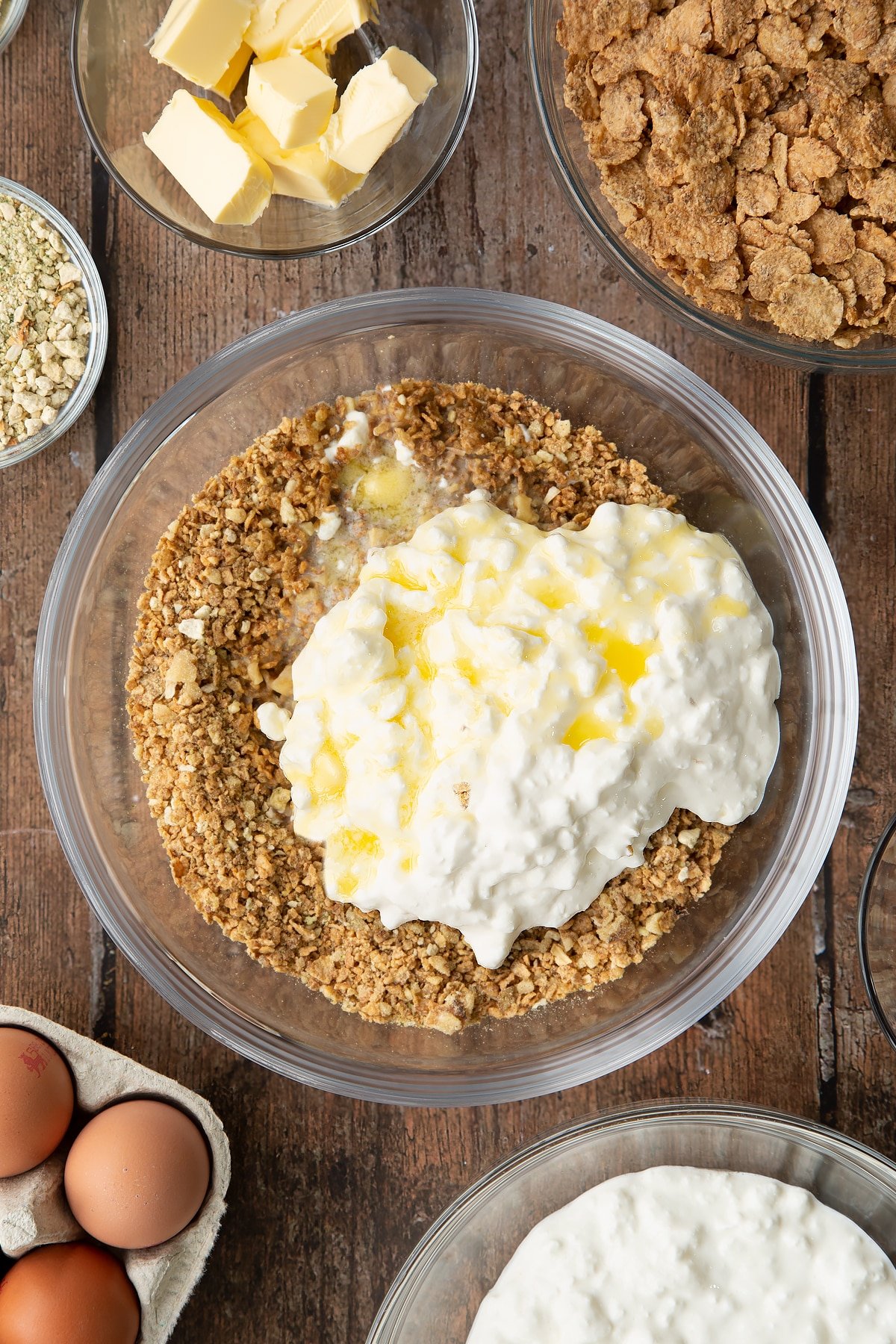 Overhead shot of some of the ingredients required to make the special k loaf together in a clear bowl.