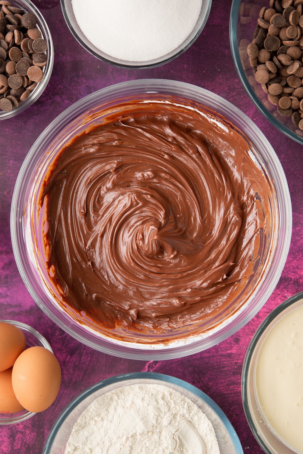 mixed chocolate and cream mixture in a large clear bowl.