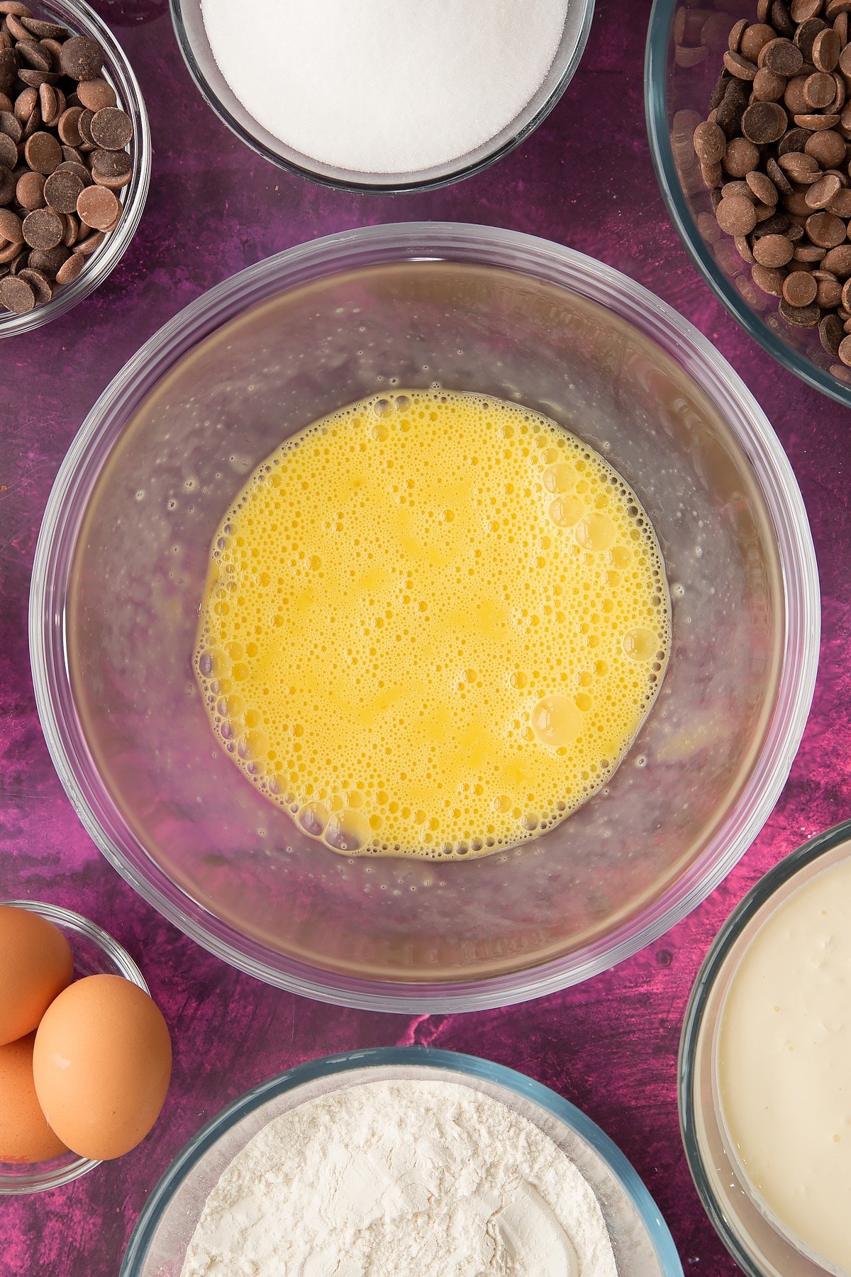 whisked eggs in a large clear bowl.