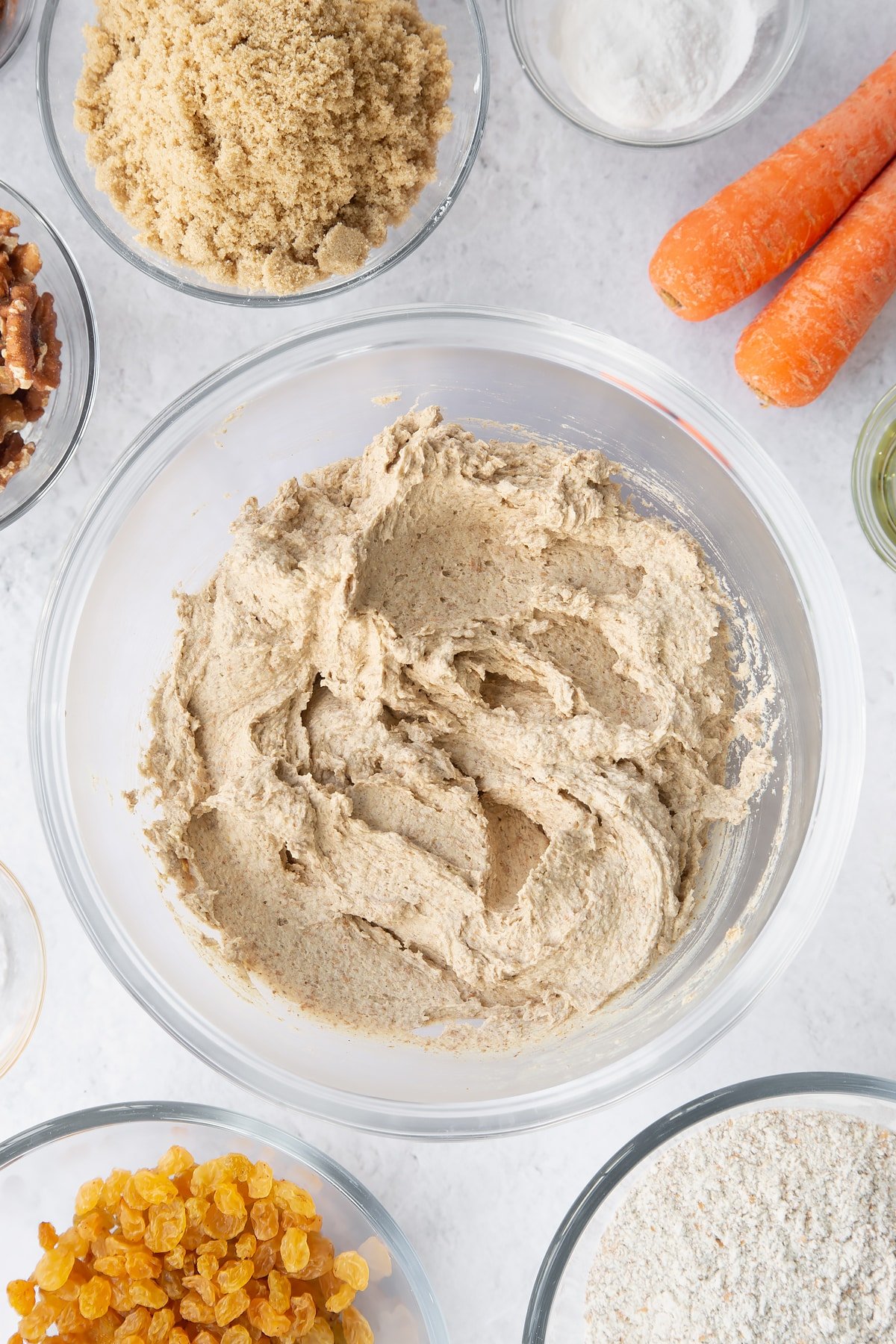 mixed Vegan carrot loaf cake batter in a large clear bowl.