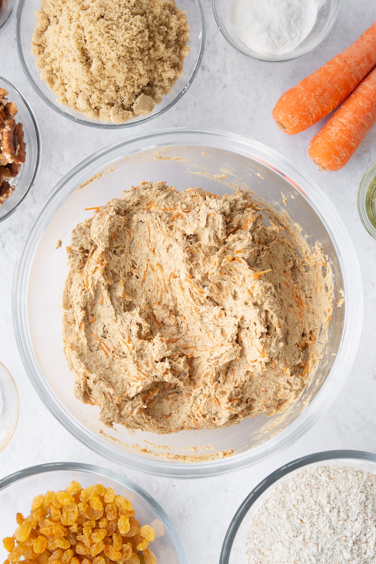 mixed Vegan carrot loaf cake batter in a large clear bowl.