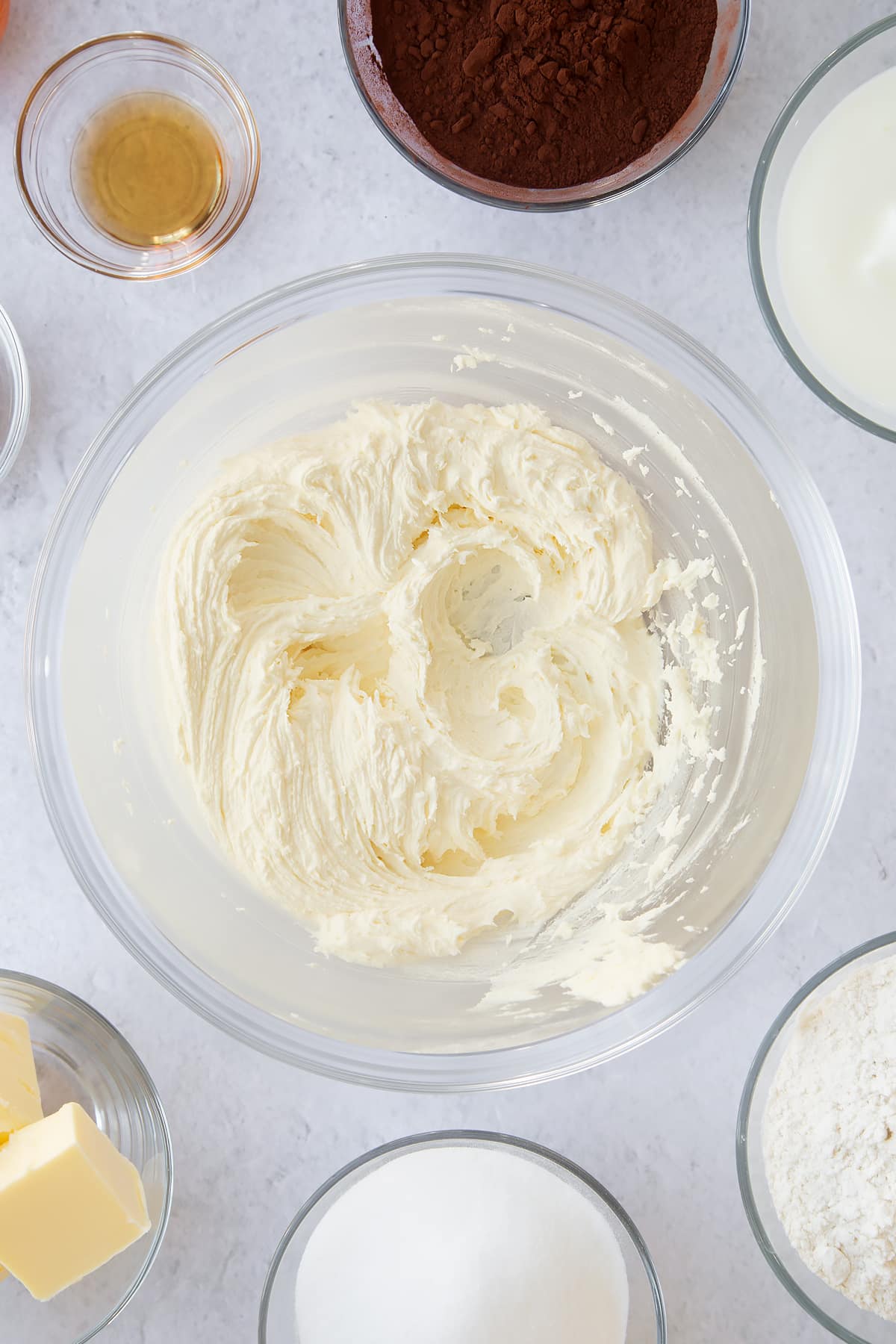 whisked butter, vanilla and icing sugar in a large clear bowl.