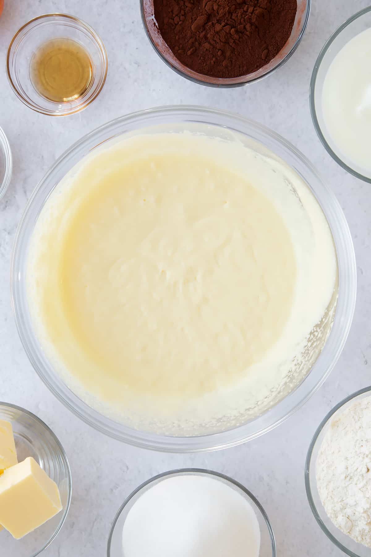 whisked buttermilk and sugar mix in a large clear bowl to create a batter.