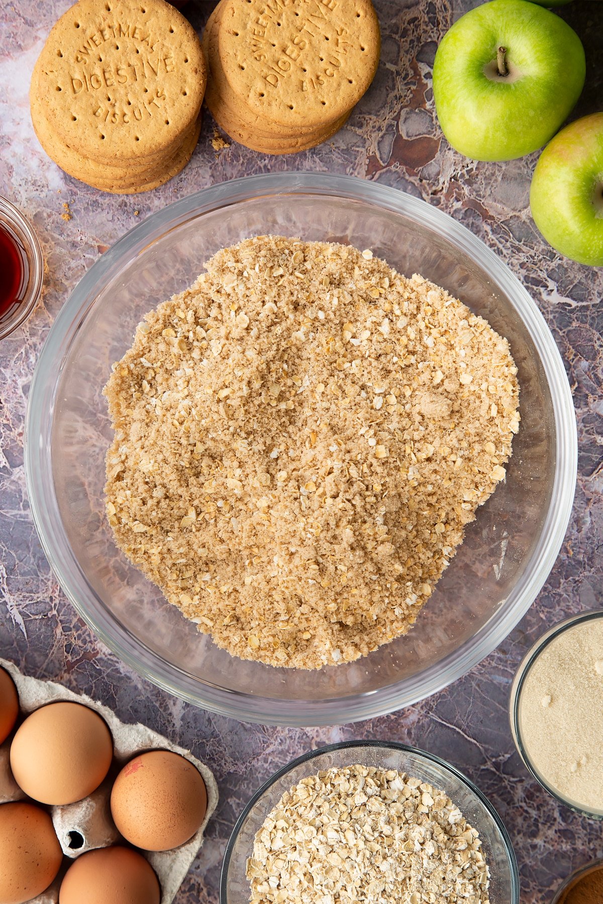 Stirring the crumble mixture together.