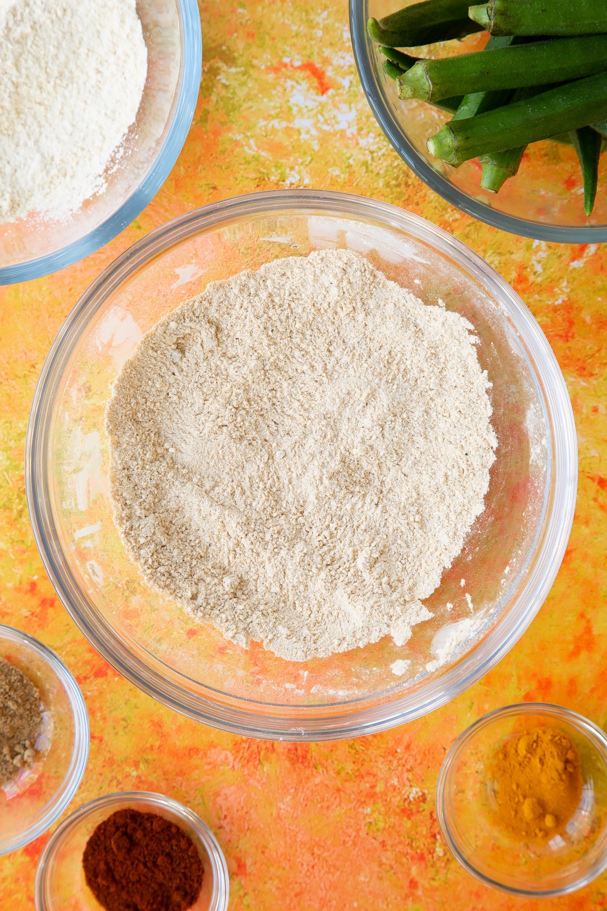 Overhead shot of the flour being mixed with the spices in a mixing bowl.