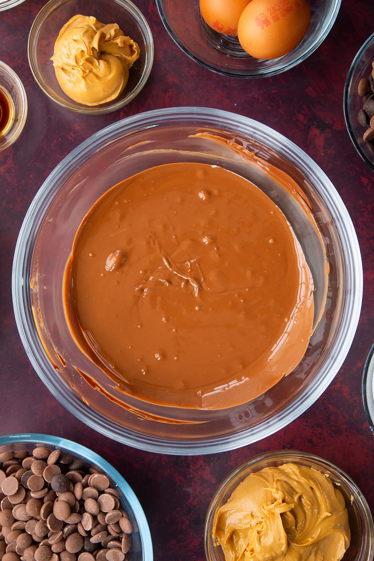melted chocolate and peanut butter mix in a large clear bowl.