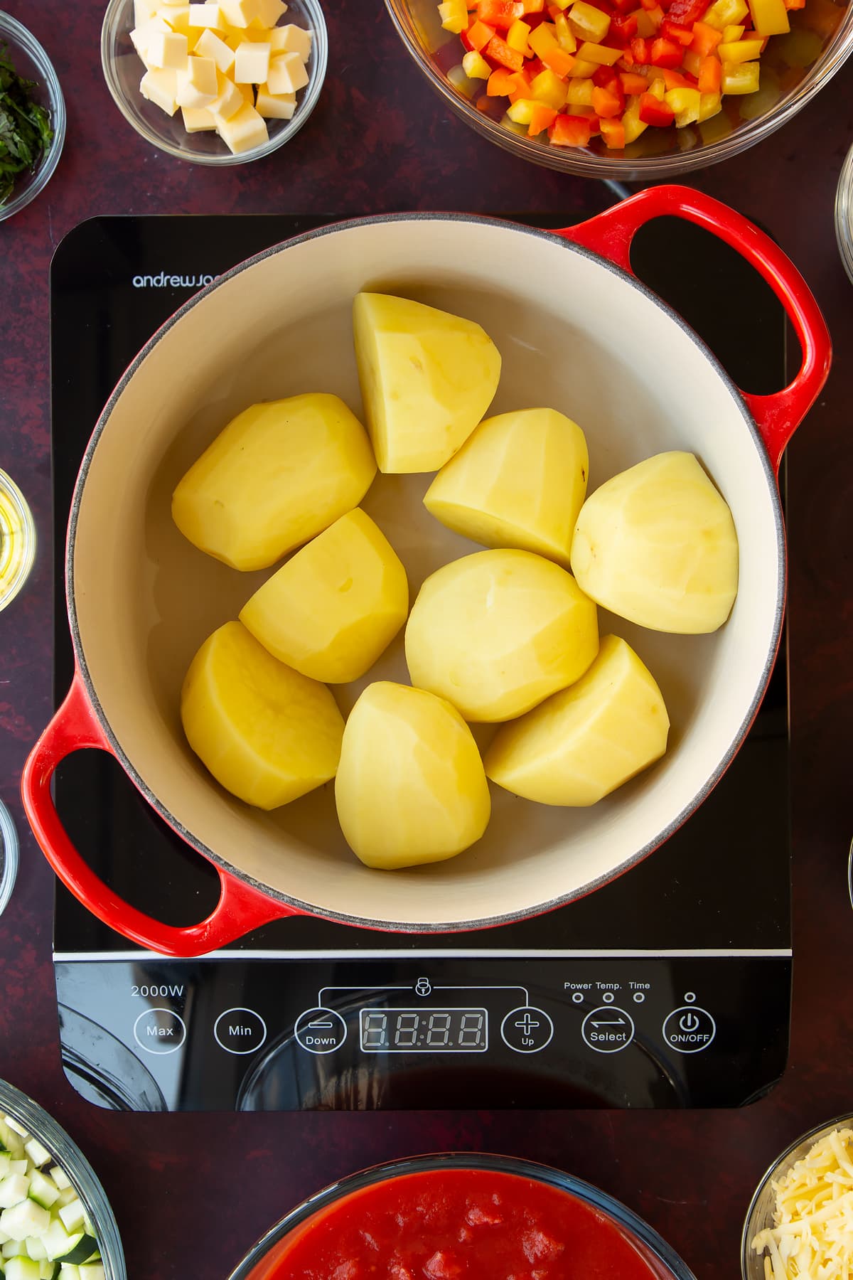 Overhead shot of a pan with potatoes which have been washed and cut.