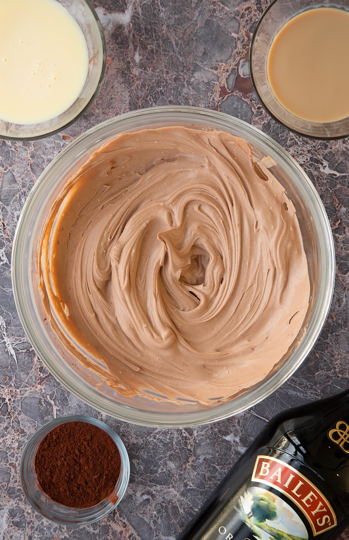 whisked baileys ice cream mix in a large clear bowl.