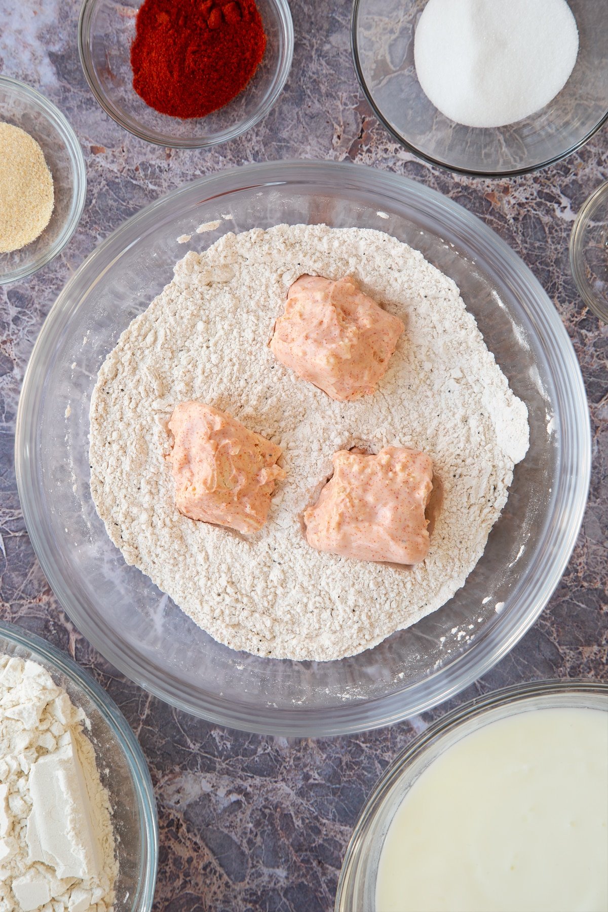 buttermilk marinated tofu pieces on top of a spiced flour mix.