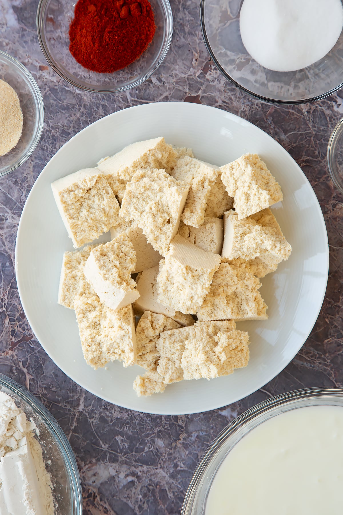 large crumbled pieces od tofu on a white plate.