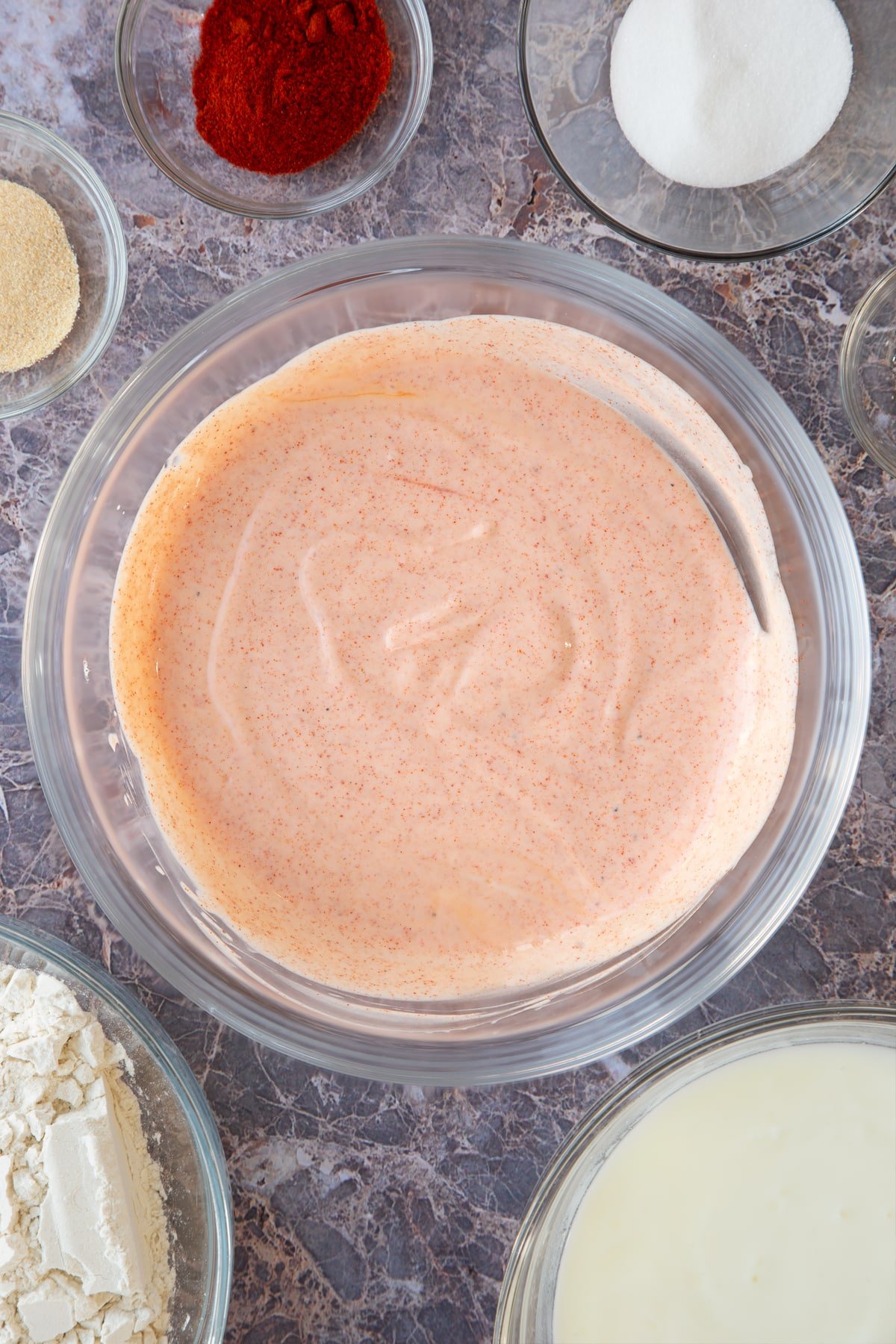 mixed buttermilk, paprika and sugar in a large clear bowl.