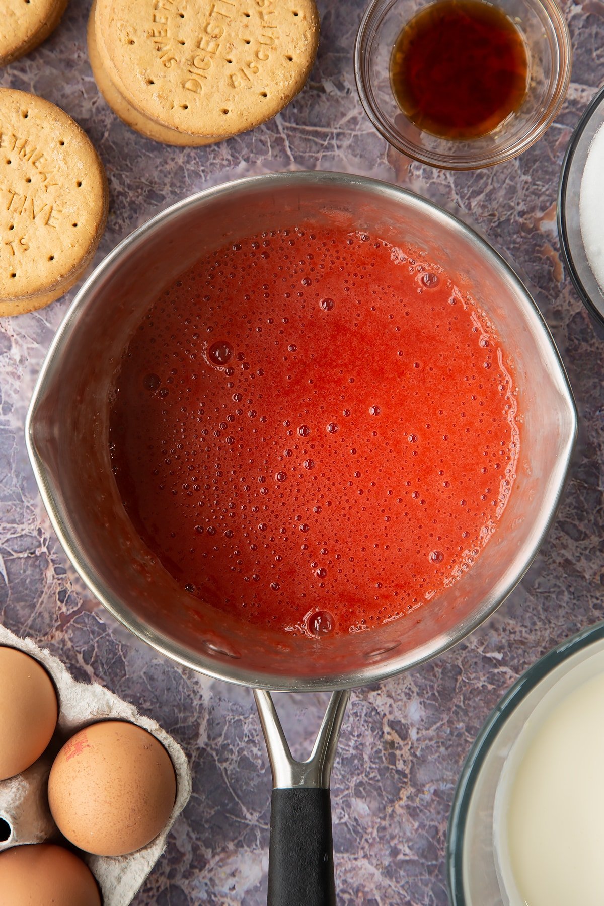 broken down strawberry and sugar mix to create a sauce in a large saucepan.