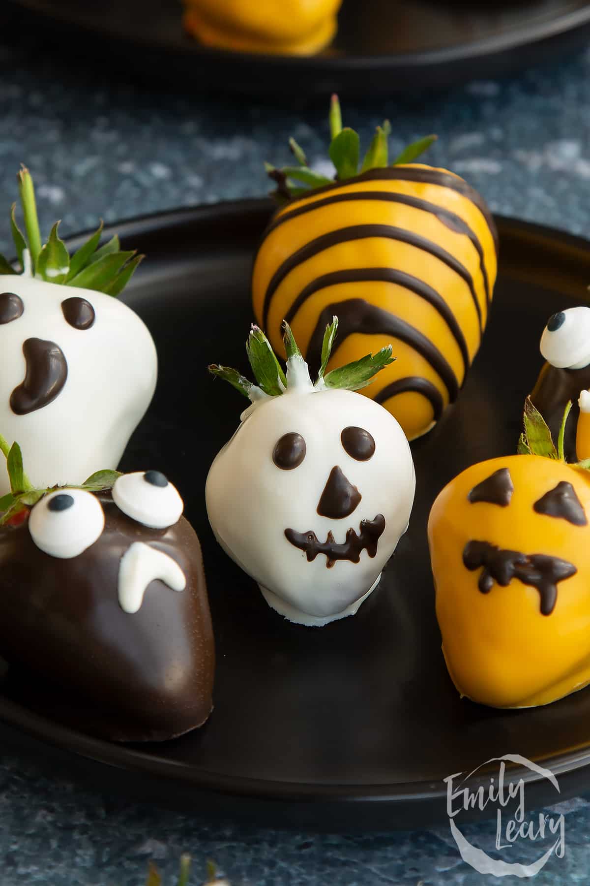 Finished plate of halloween chocolate covered strawberries.
