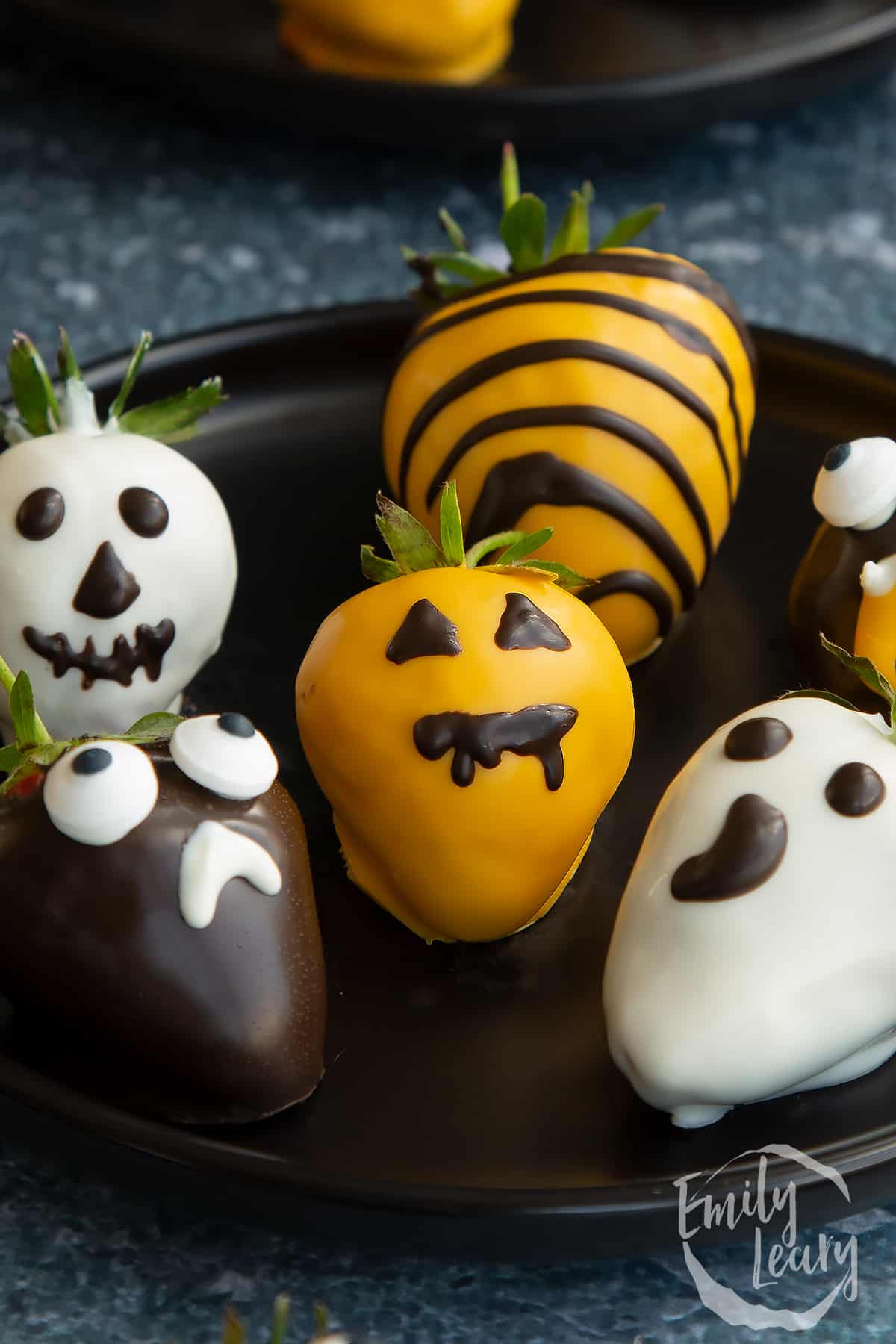 Close up shot of the finished plate of halloween chocolate covered strawberries.