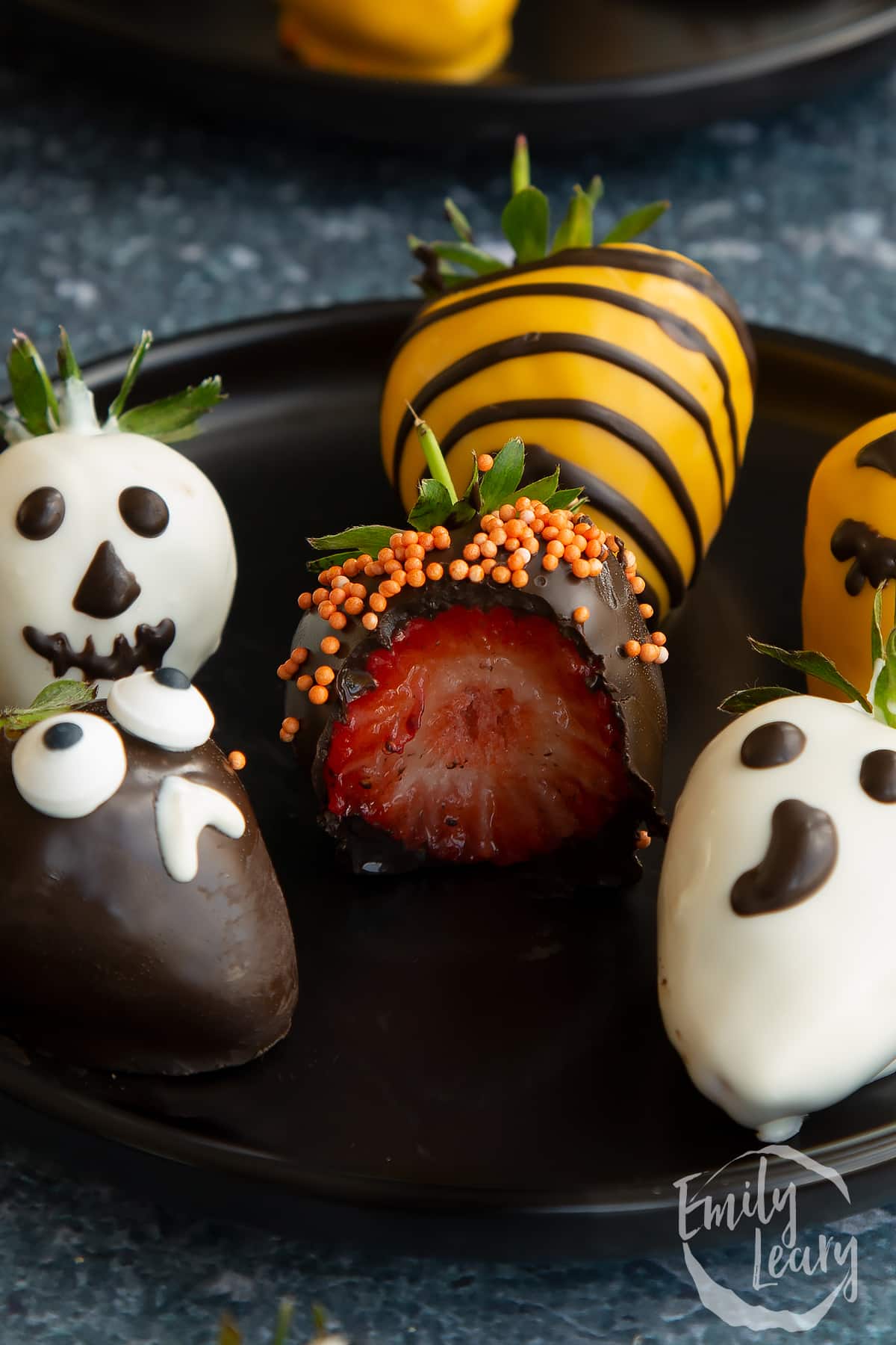 Close up shot of the cut open halloween chocolate covered strawberries.