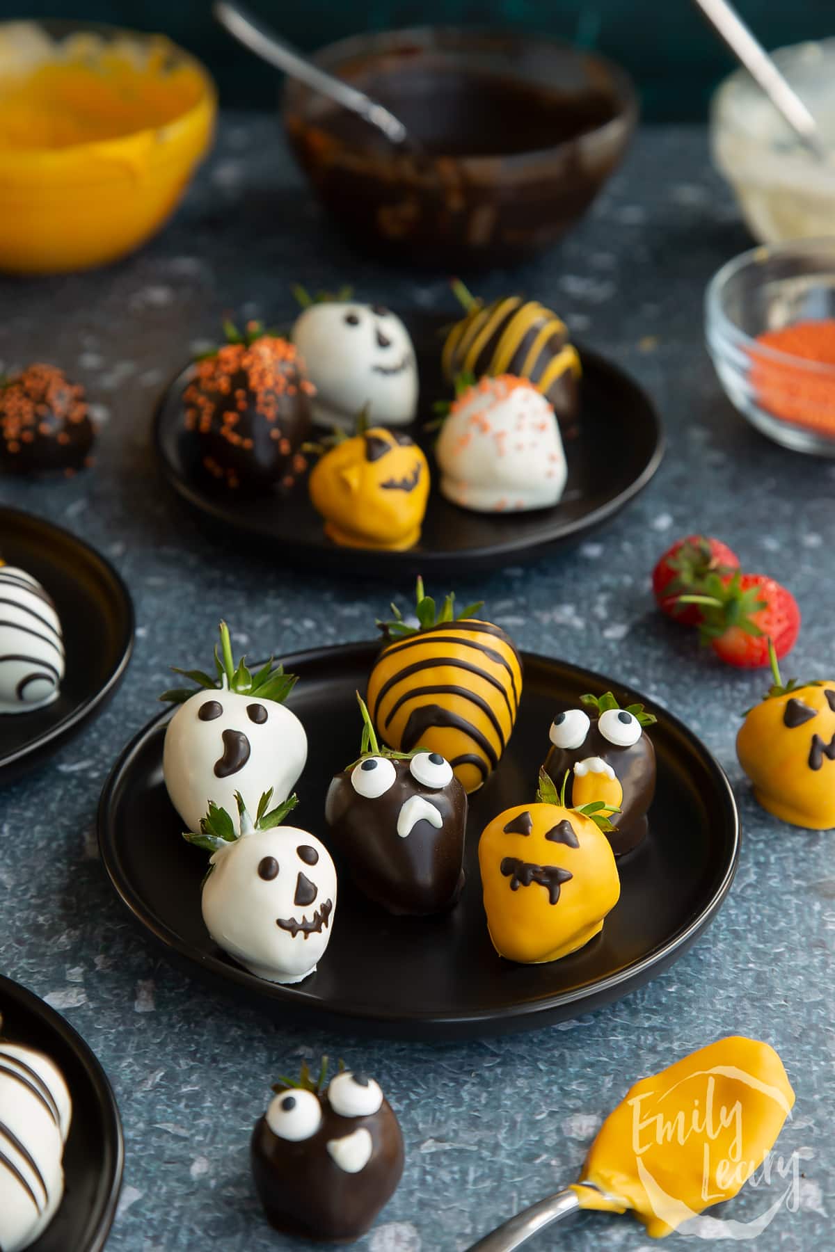 A finished plate of halloween chocolate covered strawberries.