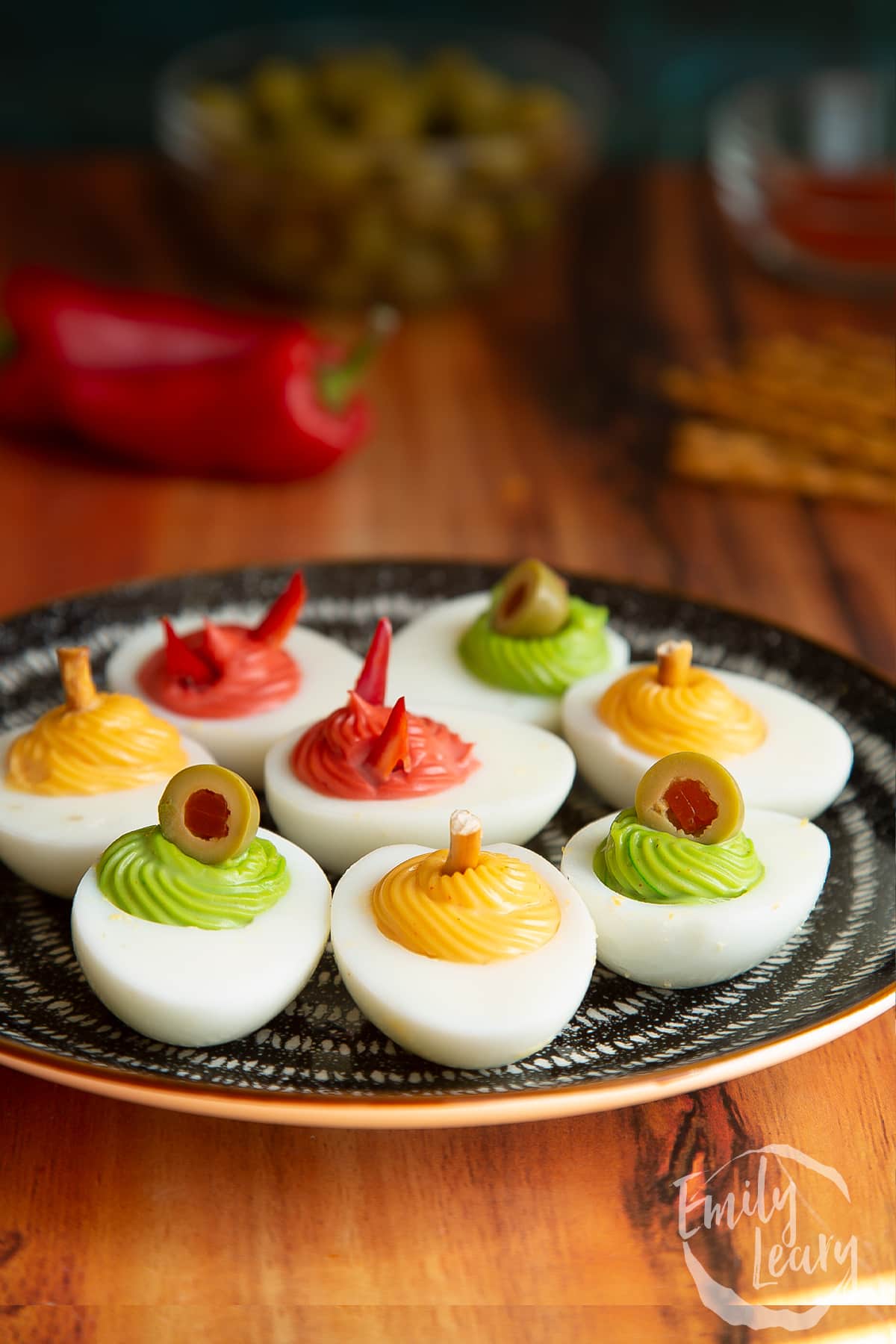 A side on shot of a finished plate of halloween deviled eggs.