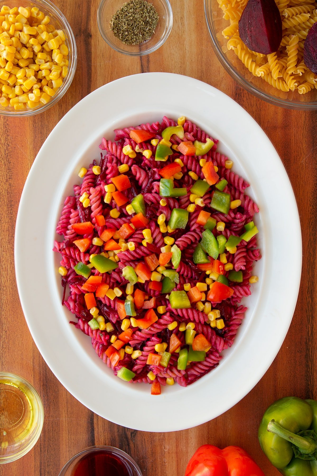 Adding chopped peppers to the already semi-assmbled halloween salad.