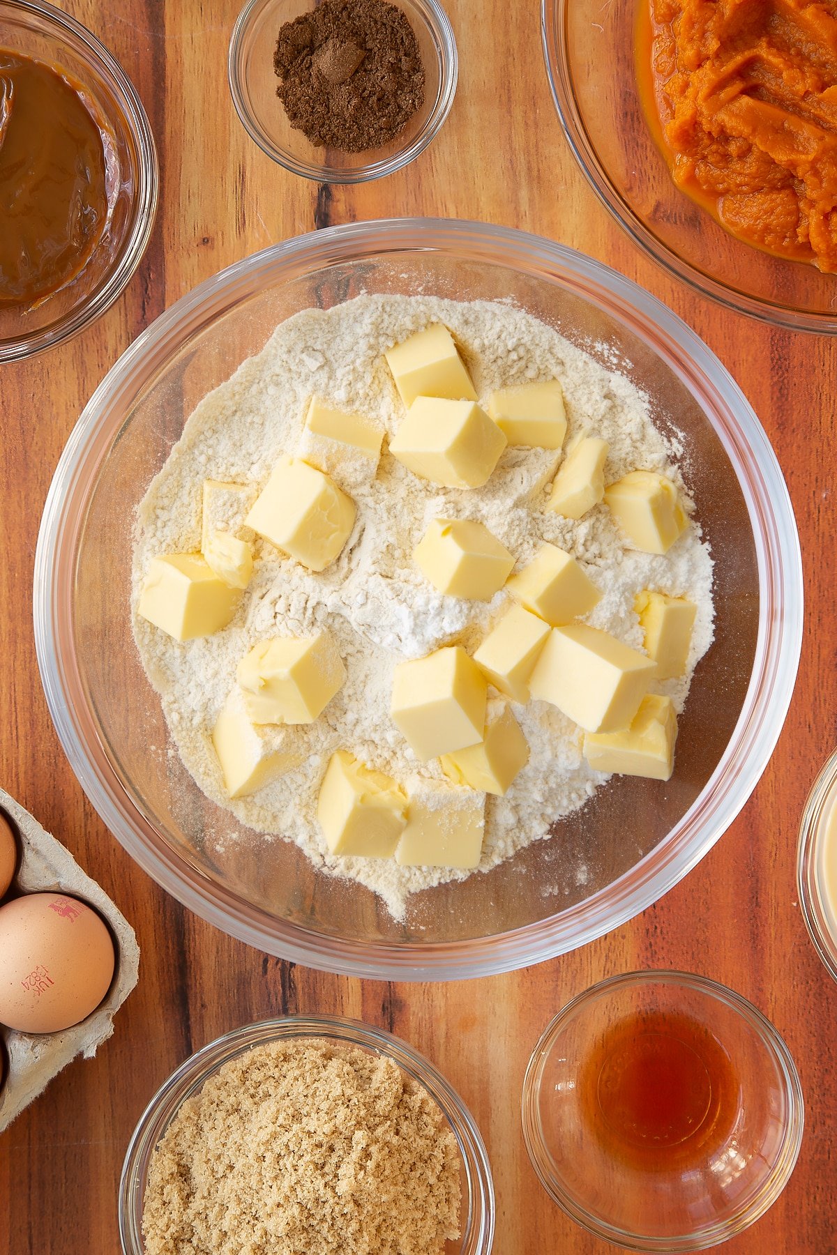 Overhead shot of a mixing bowl containing flour, icing sugar and butter.