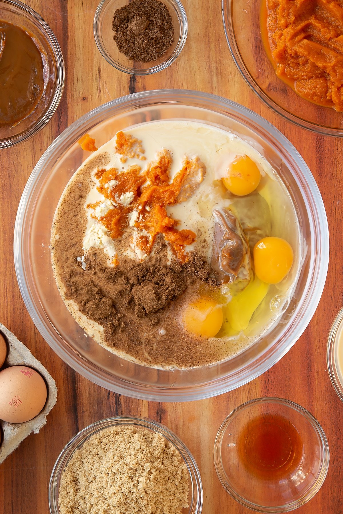 Mixing together the ingredients for the caramel pumpkin pie filling in a mixing bowl.