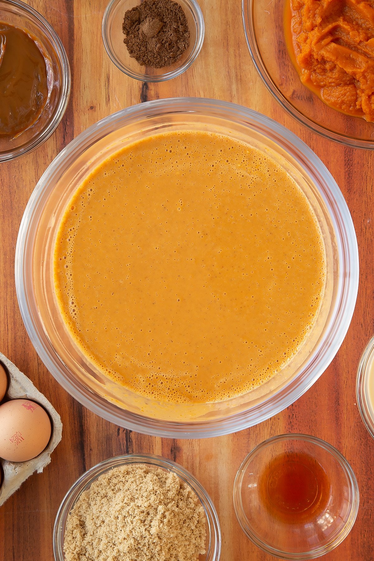 Caramel pumpkin pie filling ingredients having been mixed together in a bowl.