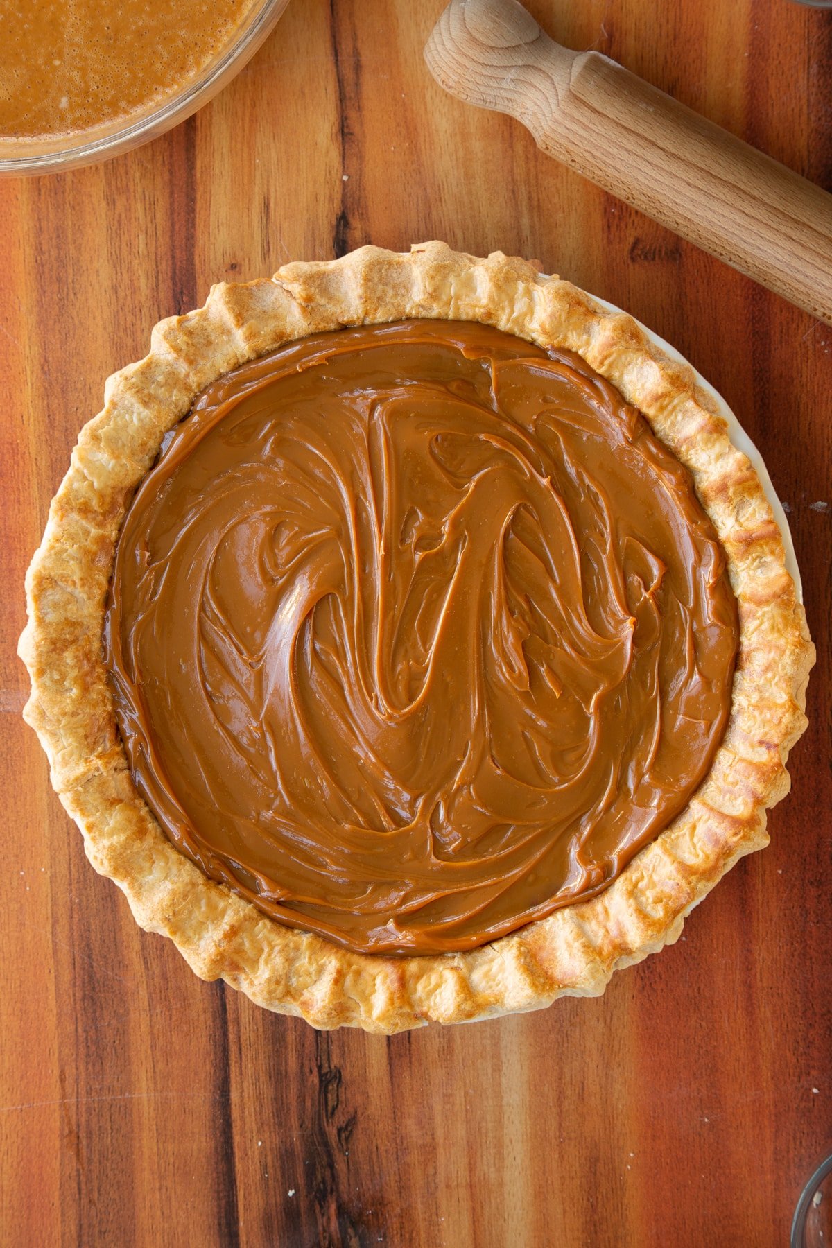 Layering the caramel onto the top of the caramel pumpkin pie.