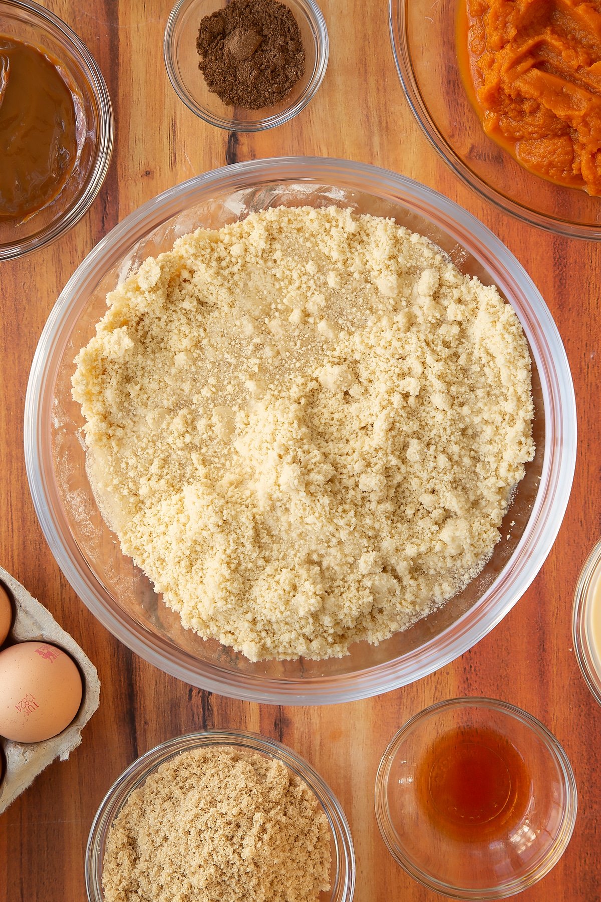 Adding cold water to the mixing bowl of ingredients.