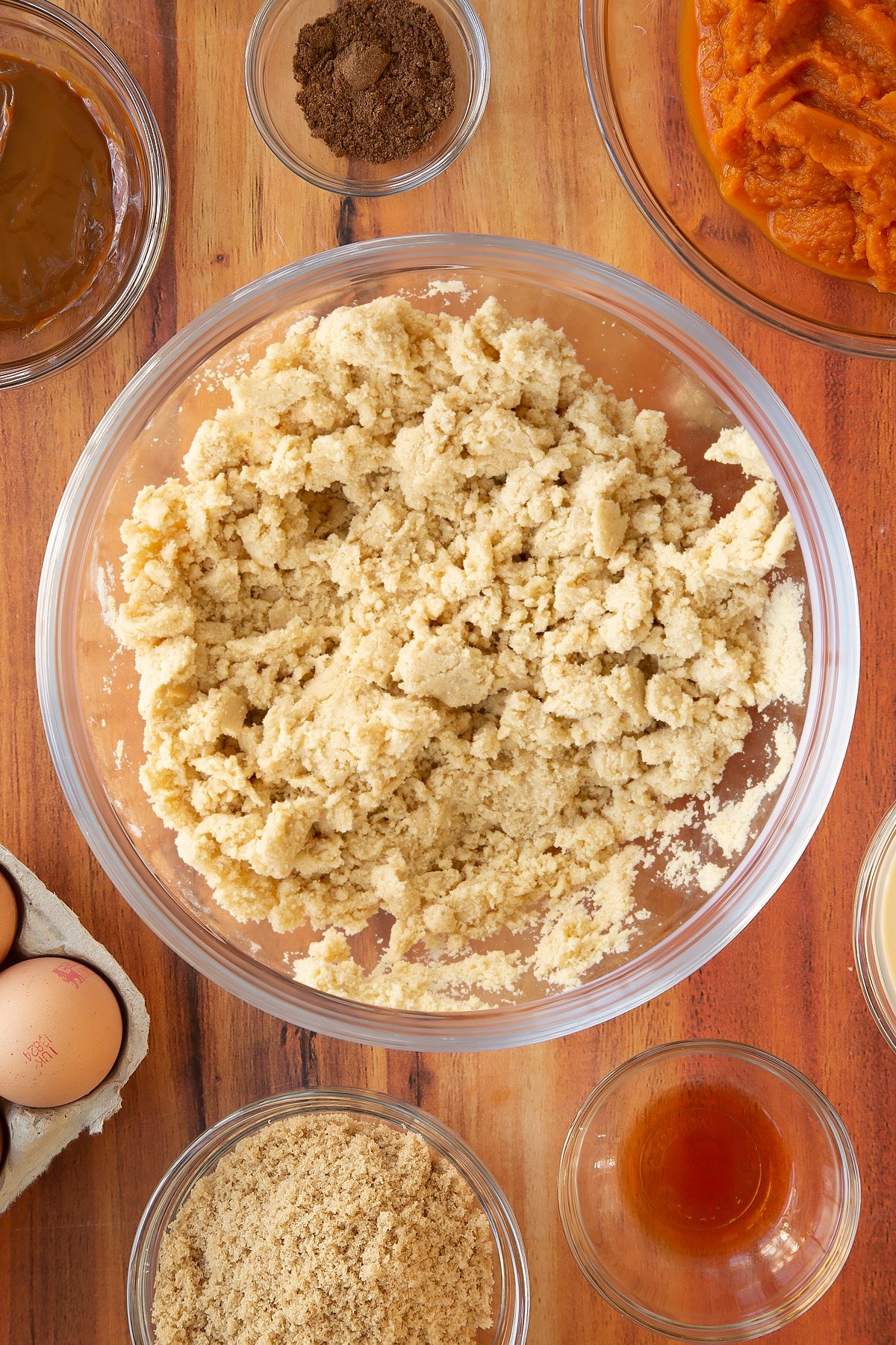 Mixing the ingredients together for the caramel pumpkin pie in a mixing bowl.