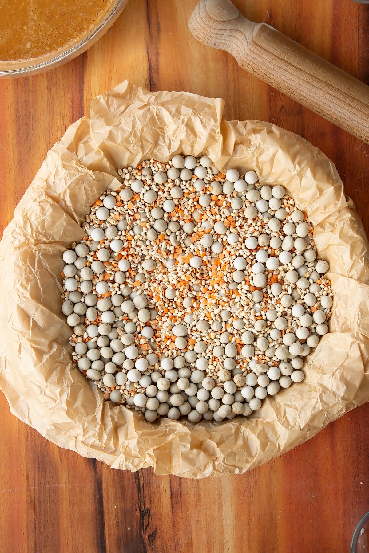 Lining the dough for the pie with baking beads.