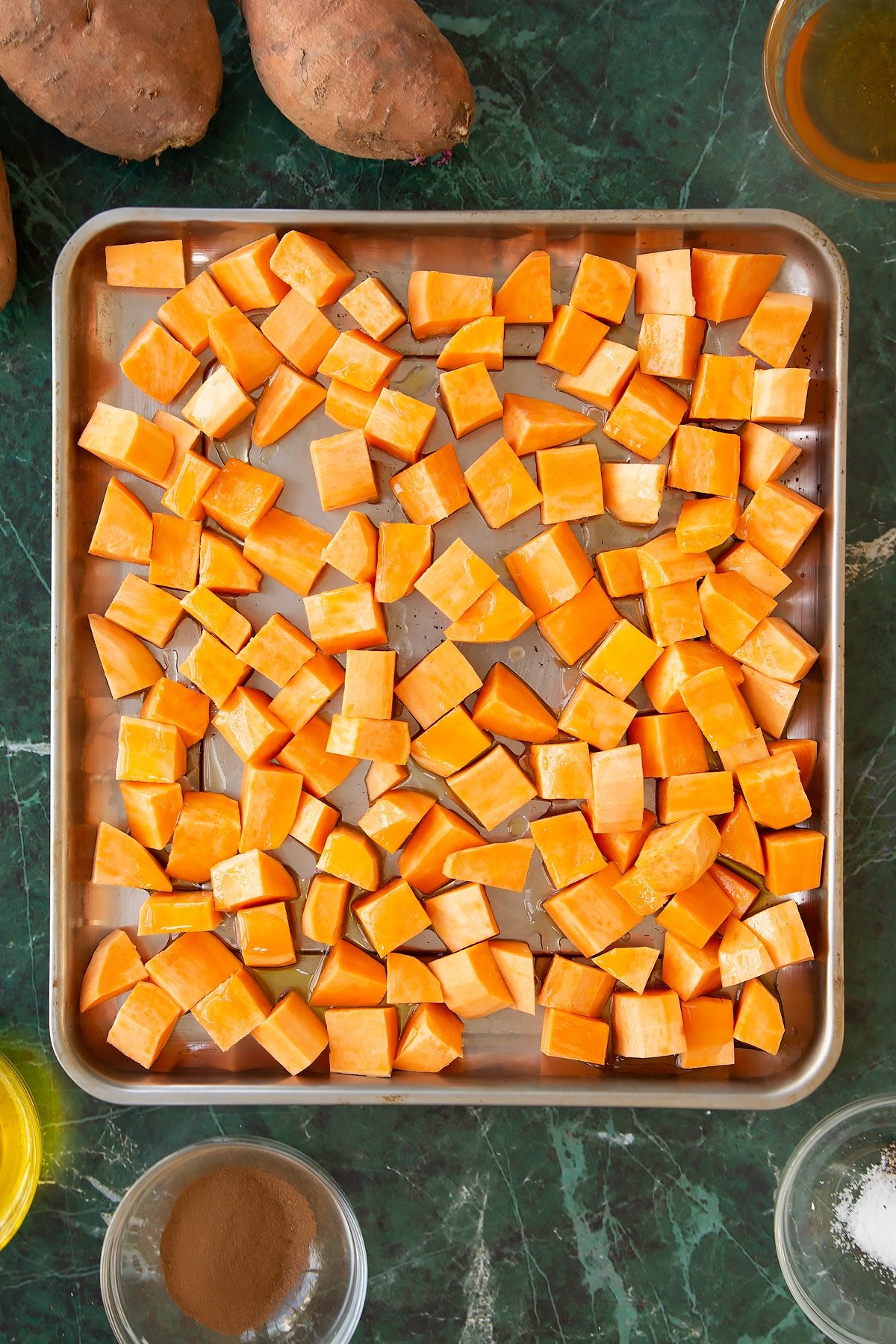 Sweet potatoes having been drizzled in oil and honey.