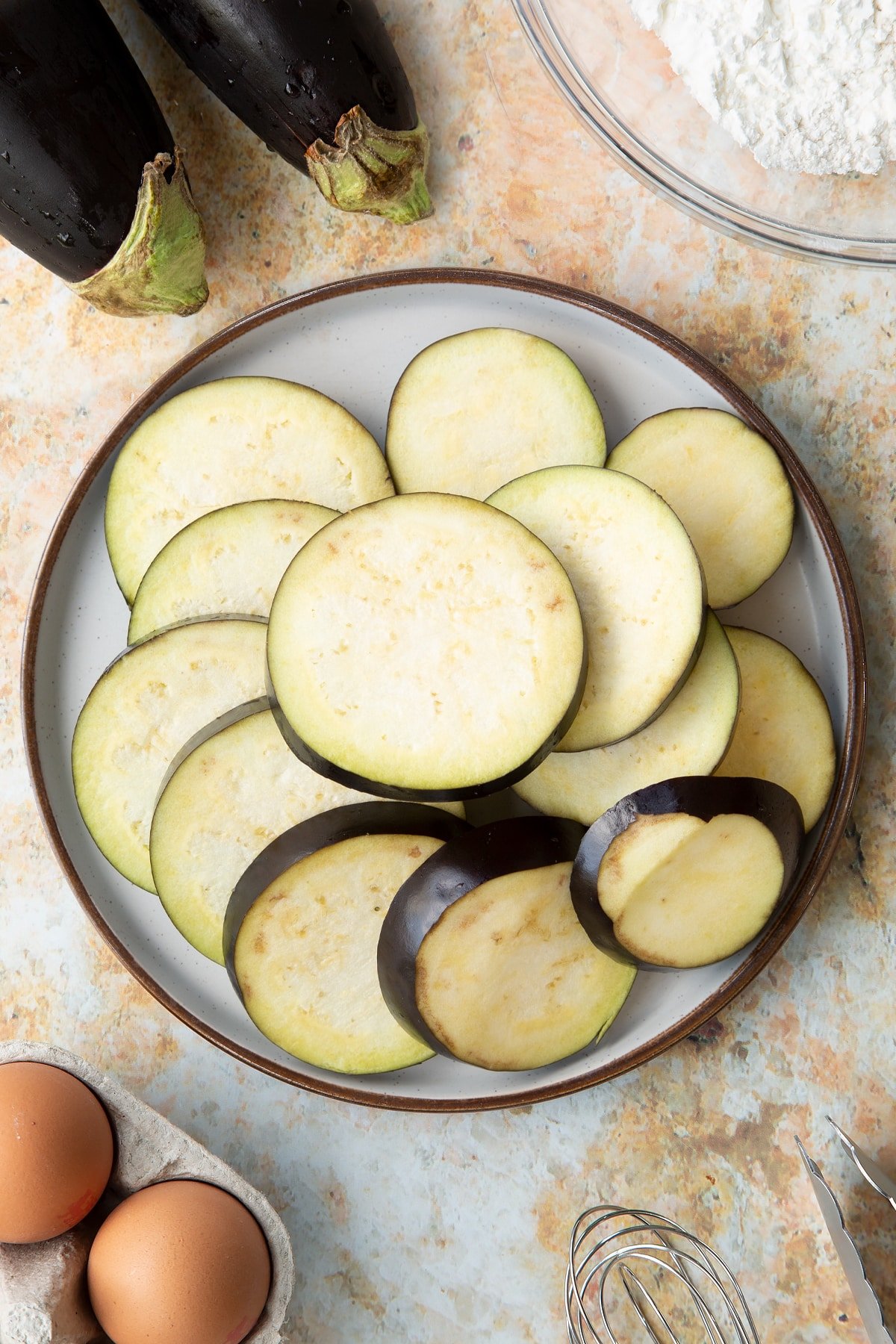 Sliced eggplant on a decorative plate.