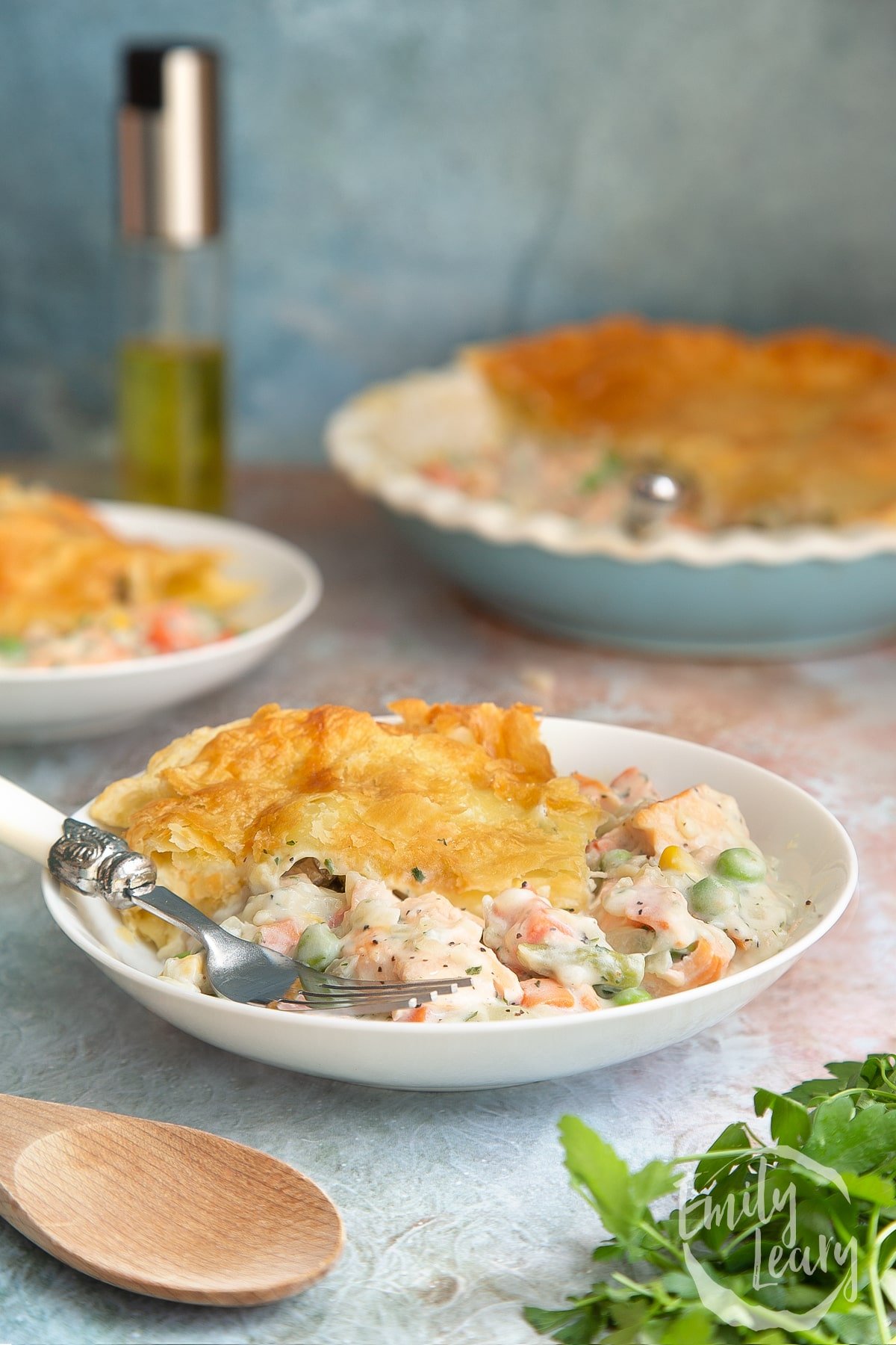 A finished bowl of salmon pot pie with a decorative fork.